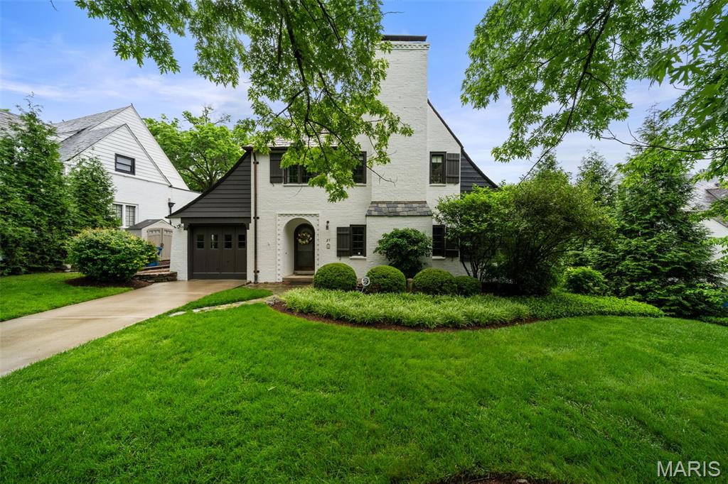Storybook cottage located on the sought-after Ridgetop Drive.  Charming, charming, charming...graceful entry foyer (20' x 11') opens to very spacious, beamed-ceiling living room with stately fireplace with 3 seating areas.  Light-filled sunroom off formal living room with hand-laid stone flooring welcomes you, ideal for a home office/study, family room or just for relaxing.  Formal dining room with French doors overlooking lush backyard, wooden-beamed ceiling, original butler's pantry is great additional storage, updated kitchen with light-colored, cherry cabinets PLUS 1st floor powder room.  Half way up the stairs is a cozy, rooftop deck perfect for enjoying the sunshine or a quiet corner to just read a book and/or lounge.  Upstairs features a very spacious primary bedroom, 2 additional bedrooms & 2 full baths.  Charming brick terrace off the rear of the home.  Garage is a 2 car tandem.  This one won't last!