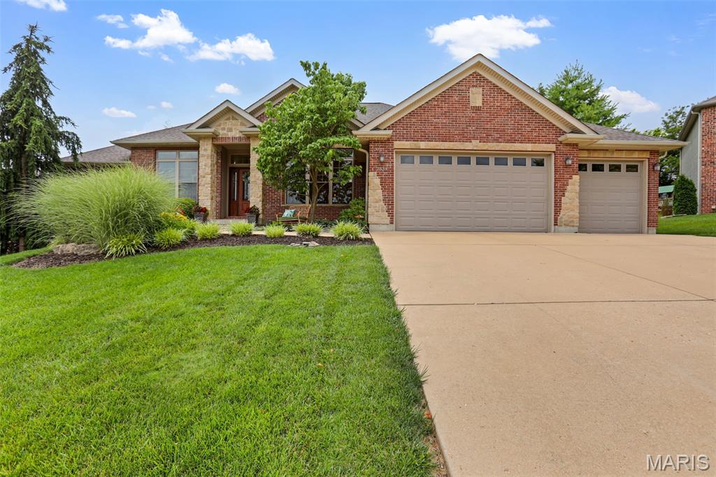 Welcome to 2334 Silver Crest Drive, beautifully situated in Stone Crest, one of Washington, Missouri’s premier subdivisions. Thoughtfully maintained and tastefully updated by it's original owner since being built in 2008, this executive-style ranch offers an exceptional blend of comfort, craftsmanship, and timeless appeal.

A stately stone-columned front porch creates an inviting first impression, leading into a spacious entryway accented by gorgeous real wood flooring. Just off the foyer, the formal dining room showcases elegant transom window details above both entry points, a custom tray ceiling with crown molding, and abundant natural light from triple front-facing windows.

The great room is warm and impressive, featuring a new electric fireplace with built-ins and soaring 10-foot ceilings that continue throughout the main level. The kitchen offers both style and function with granite countertops, stainless steel appliances, a spacious layout, continued wood flooring, and a generous 5x4 walk-in pantry. The adjoining breakfast area enjoys beautiful rear views and opens to a 17x12 screened-in deck, creating an effortless space for relaxing or entertaining.

The main level includes three bedrooms, two full baths, and an 11x5 laundry room complete with a built-in nook, storage, and bench seating—an ideal drop zone conveniently located off the oversized three-car garage. The primary suite is a true retreat, featuring a tray ceiling with crown molding, an oversized walk-in closet, and a well-appointed bath with a soaking tub, separate shower, double vanity, and spacious linen closet. The second bedroom offers exceptional versatility with a 13x11 sleeping area plus an additional 12x5 space perfectly suited for a study, gaming area, or reading nook. The third bedroom is also generously sized and thoughtfully positioned.

The finished lower level expands the living space with a comfortable family room, walkout access to the lower-level patio, two additional bedrooms, and a full bath. For added convenience, approximately 1,000 square feet of unfinished space remains, providing outstanding storage or future possibilities.

Beautifully and professionally landscaped, the outdoor areas are designed to be enjoyed. The stone firepit area offers a memorable setting for gatherings with family and friends, while the screened deck and patio provide multiple ways to appreciate the property’s peaceful surroundings.

Located within walking distance of Phoenix Park, residents can enjoy nearby walking trails, tennis and pickleball courts, and convenient access to Phoenix Center shopping. With restaurants, banks, entertainment, and commuter routes close by, this exceptional home offers refined living in a highly desirable Washington location.