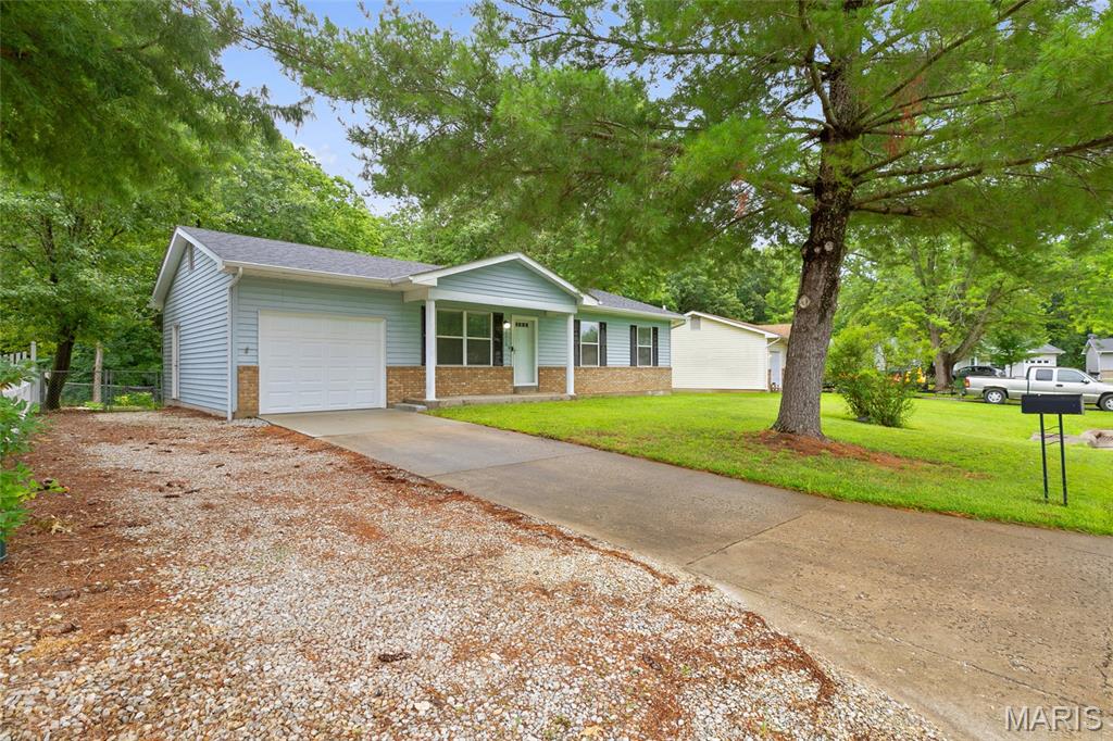 Beautifully updated and move-in ready, this 3-bedroom, 2-bath ranch is located in the heart of Warrenton! Step inside to an inviting open floor plan featuring newer laminate flooring, fresh paint, and stylish updates throughout. The remodeled kitchen is a standout with granite countertops, stainless steel appliances, abundant white cabinetry, a spacious pantry, and a center island with an integrated sink. The primary suite includes a beautifully updated private bath, while both full bathrooms have been tastefully renovated. The unfinished basement offers endless possibilities, with a full bathroom rough-in, making it ready for a future living space, recreation room, home gym, or workshop. The attached garage includes a convenient bump-out with a built-in workbench, storage closet, and side exterior door. Outside, you'll love the oversized, fenced backyard backing onto mature trees, providing plenty of space for entertaining, pets, gardening, or simply relaxing. Additional features include a newer architectural roof and an oversized two-car driveway leading directly to the attached garage, offering ample parking. Conveniently located just minutes from I-70, schools, shopping, dining, and parks, this home combines modern updates with everyday convenience. Don't miss your opportunity to own this move-in-ready home. Schedule your private showing today!