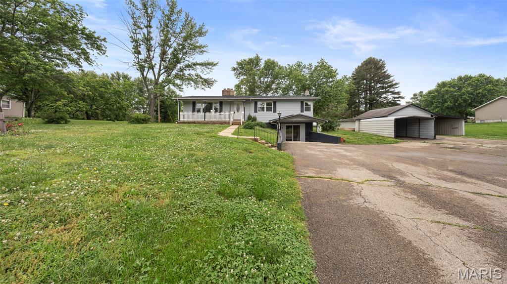 Situated on almost 1 acre in Doolittle, this spacious 3 bedroom, 2 bathroom home offers room to spread out both inside and out! The main level features a comfortable living room with a wood-burning fireplace, kitchen/dining combo, three bedrooms, and a full bathroom, while the finished basement provides additional living space with two non-conforming bedrooms, a second bathroom, a cozy freestanding propane heating stove, and a bar area perfect for entertaining or relaxing. Enjoy peaceful country living with a fenced yard, covered front porch, small shed, and an attached garage with three covered carports featuring concrete floors. Major updates include a roof replaced approximately in 2020, a furnace updated around 2015, a newer outside AC unit, and a well with a new pump. Inside, you’ll find abundant storage, including a large linen closet, a hall closet, and additional bathroom storage. The kitchen offers vinyl flooring and an electric stove, while the basement includes an additional refrigerator and a gas stove in the bar area. With plenty of space, acreage, and potential, this property is ready for your personal touch—schedule your private showing today!