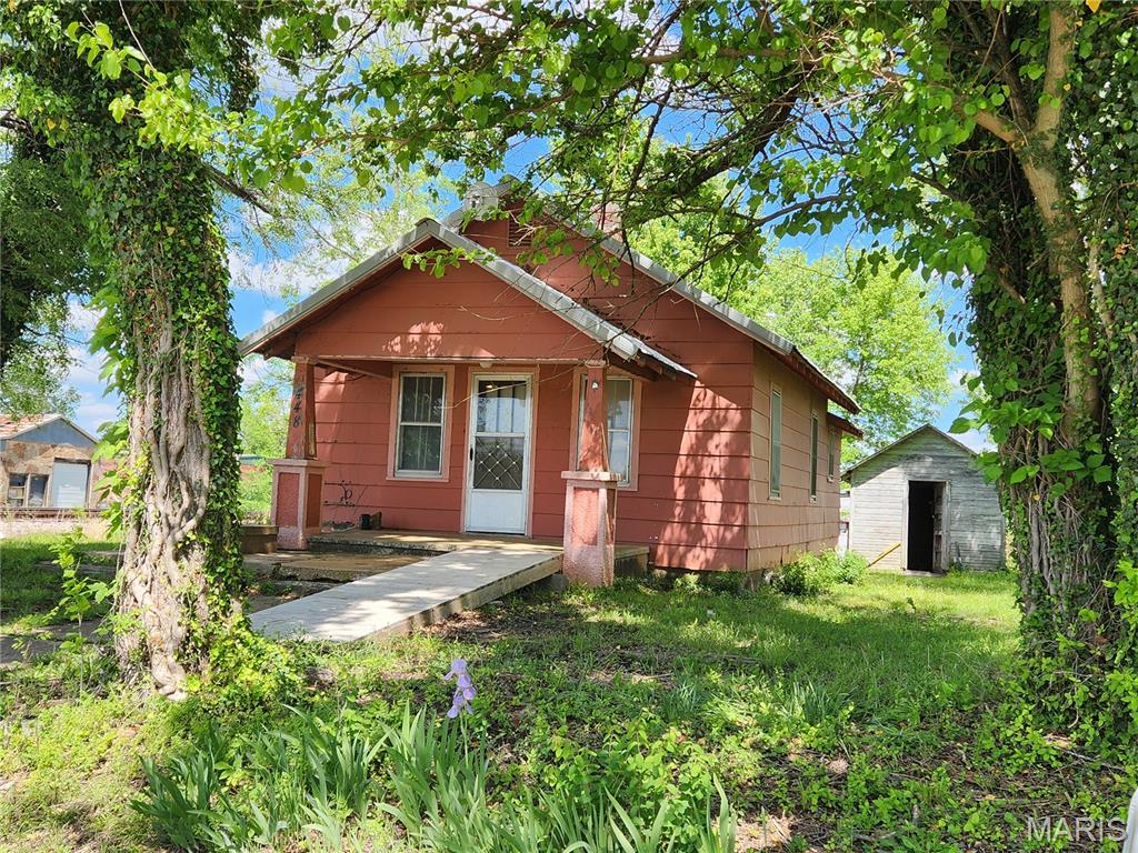This small home on a rather large lot is right in the middle of the sweet little town of Stoutland Missouri.  It's walkable to gas station/restaurant/downtown/etc.  There are two bedrooms and 1 bath, and it's never been empty long.  Recently it's been a rental, and it could use some TLC, but it's got a newer metal roof, two outbuildings, and a large shady yard plus off-street parking.  There's inside laundry too on the enclosed back porch.