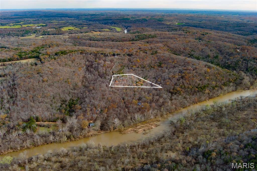 Tucked away along Hickory Lane, this beautiful 3 acre parcel offers the perfect blend of privacy, nature and opportunity. Surrounded by mature trees and the peaceful sounds of the outdoors, this is the kind of property where you can truly slow down and enjoy the outdoors. Imagine building your dream home nestled among the trees, with morning coffee on a future porch overlooking your own slice of heaven on Earth. Electric runs along Hickory Lane, giving you the option to expand and create something more permanent over time. If recreation is more your style, this property is ready for weekend escapes right now. A small sleeping cabin already sits on the land, offering a simple but cozy place to stay after a day of exploring. There is a fire pit in place, just waiting for campfires under the stars, storytelling, and evenings spent unwinding away from the noise of everyday life. The land was recently surveyed. Big River access is just a short walk or drive down the private road, making it easy to spend your days floating, fishing, swimming or simply enjoying the peaceful river setting. Brown’s Ford River access is nearby as well, adding even more opportunity for outdoor adventure. Lots A, B and C are all listed under the same address, but this sale includes the 3 acres on Lot C only with is parcel # 1390310000001922. The address will need to be updated. Whether you envision a future home tucked in the woods, a recreational retreat or a place to gather with family and friends, this property offers the freedom to create something truly special near the beauty of Big River.
