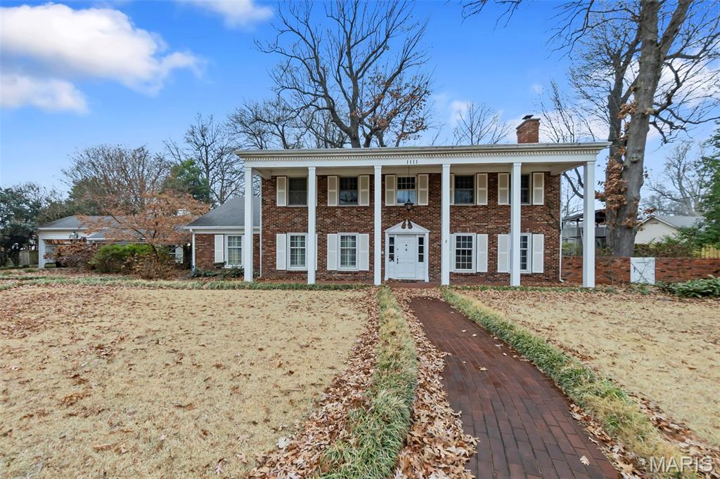 Beautiful brick Colonial-style home located in the desirable White Oak Place area of Kennett. Situated at the back of a quiet dead-end neighborhood, this property offers exceptional privacy and a secluded setting surrounded by mature trees and landscaping. The spacious backyard features brick walkways, a pergola, multiple sitting areas, and plenty of open yard space—perfect for outdoor enjoyment. Inside, you’ll find large rooms with tall, elegant ceilings throughout.

The main level includes two bedrooms, one of which is highly versatile and ideal for an office, additional living space, or flex room, complete with a private fireplace. Expansive living areas feature a second fireplace, while the kitchen offers abundant cabinet storage and a cozy sitting area. A large dining area is located just off the kitchen. The first floor also includes a utility room with a half bath.

A bright sunroom provides additional flexible space and could be used as a bedroom, office, workout room, or relaxation area. Built-ins and generous closet space offer excellent storage throughout the home. The second level features two large bedrooms and two full bathrooms, along with ample closet and attic storage. This elegant Colonial-style home offers spacious living, privacy, and beautiful outdoor spaces. Schedule your showing today.