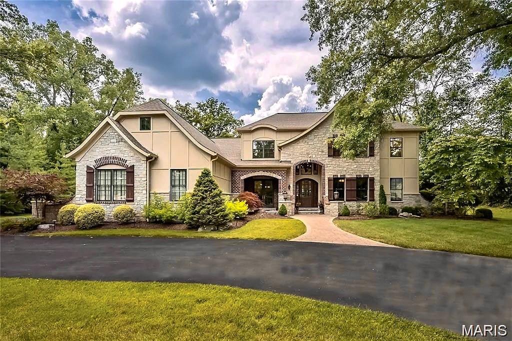 OPEN HOUSE SEPT 21--Your chance to see this outstanding property, now price improved with a brand new roof coming soon! Casual elegance best describes this 5 bedroom, 4 full 2 half bath home nestled on a picturesque 1+-acre lot in the heart of Frontenac.  With over 7,200 sq feet of luxurious living space, this stunning home seamlessly combines formal and informal spaces in a sophisticated, thoughtful floorplan. Soaring ceilings, classic millwork and gleaming hardwood flooring extend throughout the main level, with gorgeous architectural details everywhere you look. The paneled office features a coffered ceiling, while an impressive great room overlooks the patio and lush backyard. The open floorplan kitchen, breakfast room and family/hearth room are highlighted by a natural stone fireplace, creating the perfect setting for family and any guest occasion.  The main level primary bedroom suite is a true retreat, with tray ceiling, walk-in closets and a spa-like bathroom, complete with bubble tub and large walk-in shower. Upstairs, a family room/loft area and three additional bedrooms (one is ensuite) are spacious and welcoming. The jaw-dropping lower level has been newly refreshed and includes a custom wet bar, temperature controlled wine room, workout space, rec room/media room and a comfortable bedroom suite. With its impressive 4-car garage and ideal location near shops and Ladue Schools, this is truly an estate not to be missed!