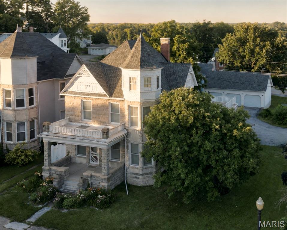 Rarely does a home of this architectural significance become available at such an attainable price. Owners relocating and have stopped a couple projects for you to resume according to your desires, providing the opportunity to sell at a lower "as is" price point - a distinguished Queen Anne Victorian residence in the charming river town of Louisiana, Missouri. Built in 1891 for prominent merchant Adam Wald, this remarkable home stands as a testament to the prosperity, craftsmanship, and architectural elegance of Louisiana's thriving river-town era.

Situated on three lots totaling just under one-half acre, the home is constructed of stone, brick, and frame and showcases beautifully preserved original woodwork, a grand oak staircase, spacious formal living and dining rooms, and architectural details that have remained intact for well over a century. Thoughtful updates blend seamlessly with the home's historic character, offering modern conveniences while preserving its timeless beauty.

Adam Wald, whose family owned and operated one of Louisiana's largest mercantile establishments, commissioned the home during one of the community's most prosperous periods. It is one of three adjacent homes built for the Wald family. Originally estimated to cost $2,000 each to construct, the homes ultimately exceeded expectations, with final construction costs reaching an impressive $4,250 each—a considerable investment in 1891!

Located on historic North Third Street, the property is within walking distance of downtown shops, restaurants, the library, and the Mississippi River. Continue your stroll north along Third or Main Street, passing other impressive historic homes, and you'll arrive at Henderson Park (also known as Riverview Park), where breathtaking views of the Mississippi River, the Illinois bluffs, and the surrounding river valley await.

The property includes a private drive and a detached three-car garage that offers abundant space for vehicles, a workshop, hobbies, or the perfect gathering spot. A large screened porch, added in the 1980s, is currently being transitioned into a three- or four-season room, giving the next owner the opportunity to complete the project or restore it to its original screened-porch design.

Whether you're entertaining guests, admiring the exceptional craftsmanship of a bygone era, or simply appreciating the rich history behind its walls, this home offers a rare combination of historic significance, charm, and everyday livability.

More than a home—it's a remarkable piece of Louisiana history.