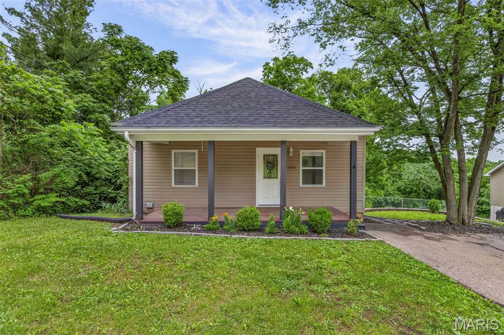 Welcome home to this charming and beautifully updated 2-bedroom, 1-bath ranch nestled on a private half-acre lot in Herculaneum! Whether you're a first-time home buyer or looking to downsize, this home is full of character, space, and potential. Step inside and immediately notice the soaring 9-foot ceilings throughout the main level, creating an open and airy feel in every room. Warm, inviting colors and hardwood flooring make the living space feel cozy and welcoming. The spacious primary bedroom features a double closet and convenient main-floor laundry hookups for added flexibility. The large eat-in kitchen offers an abundance of cabinet storage, generous counter top space, and updated stainless steel appliances—perfect for everyday living and entertaining alike. A second bedroom and updated full bath with shower and linen storage complete the main level. Downstairs, the walk-out lower level provides endless possibilities with additional laundry space, two bonus rooms ideal for a home office, gym, or hobby area, plus a workshop and over-sized storage area with double-entry doors—perfect for lawn equipment, motorcycles, boats, or recreational toys. Step outside to enjoy the newly built back deck overlooking the peaceful, private backyard surrounded by woods and wildlife. This over-sized fenced lot offers the perfect setting for relaxing evenings or entertaining guests.