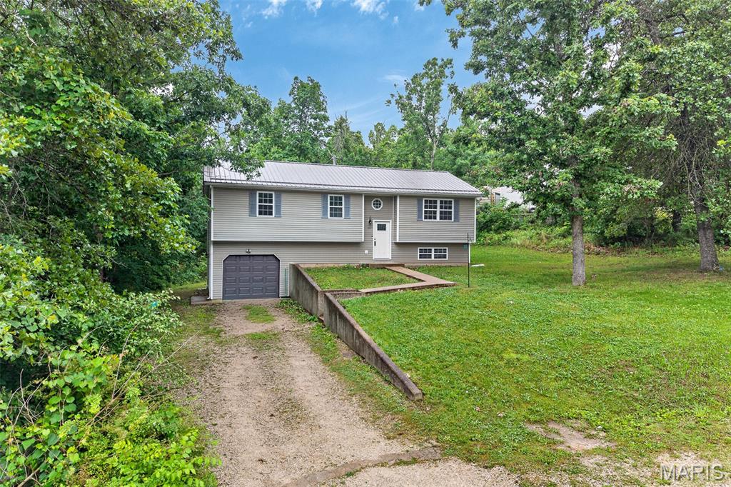 This beautiful home is tucked away at the end of a street and backs up to the woods of Fort Leonard Wood. The inside has been completely remodeled with new floors, carpets, appliances & cabinets. Even the water heater, water softener, HVAC and roof have been replaced recently. The basement even has a fun Harry Potter room under the stairs.