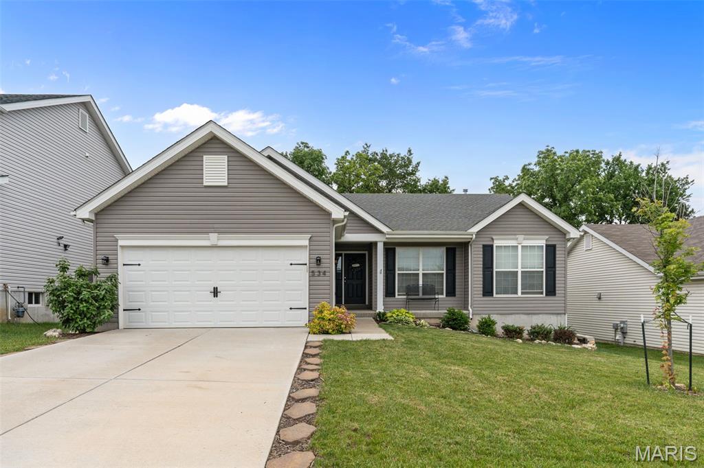 Welcome to this beautiful newer construction 4 bedroom, 3 bathroom ranch home! Built just 4 years ago, this home features an open floorplan with vaulted ceilings in the kitchen, dining area, and great room, with plenty of space to entertain. Wood laminate floors run throughout the main living areas, tying the space together. The kitchen boasts 42 inch cabinetry, stainless steel appliances, and a corner walk-in pantry. Your spacious backyard awaits, walking out your dining area just off the kitchen. The main floor primary suite offers ample closet space and a beautiful bathroom with dual vanities and separate bathtub and shower. Two additional bedrooms round out the space. Downstairs has been professionally finished adding a spacious family room, bedroom with walk-in closet, and stunning full bathroom, while still leaving plenty of room for storage. Convenience abounds with a two-car attached garage, main-floor laundry, and low-maintenance vinyl siding! You’ll love the neighborhood amenities including a playground, sports court, and pavilion for all your summer gatherings!