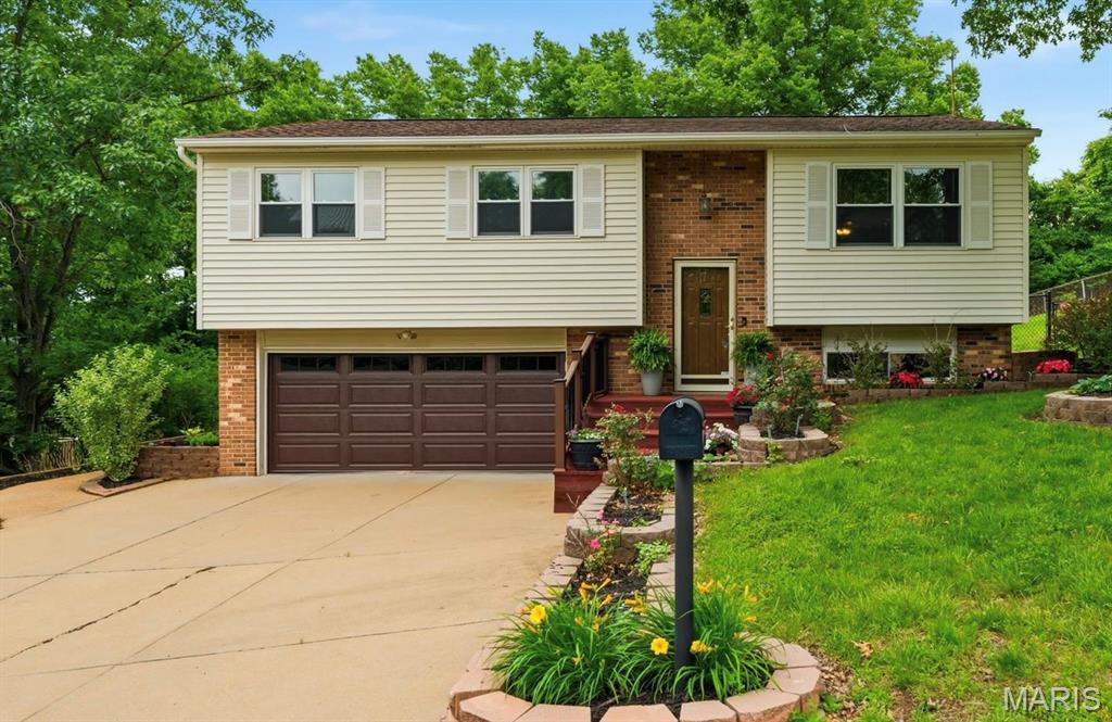 Welcome home to this beautifully updated 3-bedroom, 3-bathroom gem nestled in the heart of Fenton! From the moment you step inside, you’ll be captivated by the stunning custom inlaid hardwood flooring, abundant natural light, and inviting open-concept layout designed for both everyday living and effortless entertaining. The spacious chef’s kitchen is a true showstopper, featuring granite countertops, stainless steel appliances, and an abundance of cabinetry for all your storage needs. Flow seamlessly from the kitchen into the dining and living spaces, then step through the sliding glass doors to your own private backyard retreat. Enjoy a fully fenced, level yard complete with an above-ground swimming pool, peaceful scenic views, and the perfect setting for relaxing summer evenings or weekend gatherings. The main level also offers two generously sized secondary bedrooms, a full hall bathroom, and a spacious primary suite with its own private en-suite bathroom. Downstairs, the finished lower level provides endless possibilities with a large recreation area ideal for a home office, gym, playroom, media room, or additional family space. A third bathroom and utility area with laundry complete the lower level. Car enthusiasts, hobbyists, and DIY lovers will appreciate the oversized two-car garage with extra room for a workshop or additional storage. Conveniently located just minutes from Gravois Bluffs, downtown Fenton, and with quick access to Highways 141, 30, and 55, this home truly combines comfort, style, and convenience in one incredible package. This is one you won’t want to miss—schedule your private showing today!