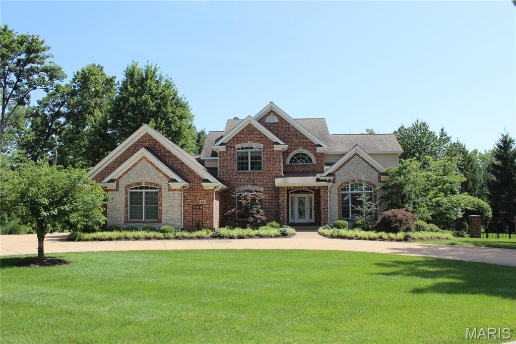 This stunning 1.5-story home in the highly sought-after Ladue School District offers 5 bedrooms and 6 bathrooms, seamlessly blending timeless elegance with modern luxury. Originally built in 2005, the home underwent an extensive 2024 renovation that thoughtfully transformed the main level into warm, inviting living spaces with exceptional finishes throughout.
At the heart of the home is the beautifully designed kitchen and hearth room, featuring custom 42-inch white cabinetry, quartz countertops, a Sub-Zero refrigerator, double Wolf ovens, an induction cooktop, a spacious walk-in pantry, and wood flooring. A convenient main-floor laundry room is located just off the kitchen. The kitchen flows into the inviting hearth room, where a see-through gas fireplace creates a cozy focal point for everyday living and entertaining. A butler’s pantry with a wine cooler and refrigerator drawers adds both style and functionality.
Just off the kitchen, a covered composite deck provides the perfect place to relax and overlooks a beautifully designed stone patio complete with its own outdoor fireplace—ideal for gatherings or quiet evenings at home.
The living room features a gas fireplace, while the dining room offers an elegant space for entertainment. The spacious main-floor primary suite is a true retreat, showcasing a tray ceiling, walk-in closets, and a luxurious, updated bath with dual vanities, a heated towel bar, a soaking tub, and a large separate shower.
Upstairs, you’ll find 4 additional bedrooms, 3 full bathrooms, and a convenient laundry closet, offering ample space and flexibility for family and guests.
The finished lower level expands the home’s living space with a comfortable sitting area featuring a gas fireplace and a bar with cabinetry, a sink, a small refrigerator, a dishwasher, and an ice maker. A cozy stone fireplace highlights the lower-level office. Additional highlights include a cedar closet, a recreation area ideal for a pool table, a workout room, and abundant unfinished storage space.  An oversized three-car garage.  Ideally located just off Spoede Road, the home is minutes from shopping, dining, and major highways, offering the perfect balance of privacy and convenience.
This beautifully updated home offers refined comfort and exceptional living in one of the area’s most desirable locations