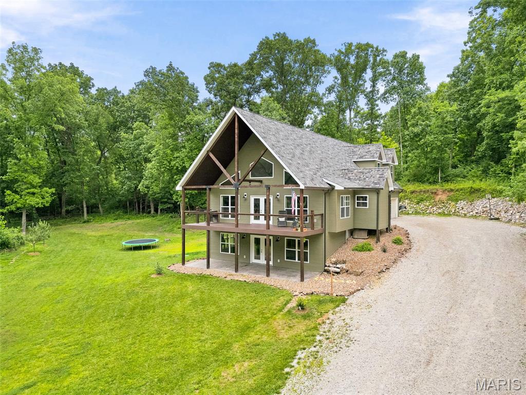 Welcome to your private retreat! Nestled on 3 beautiful acres surrounded by mature trees, this spacious 3,400 sq. ft. home offers the perfect blend of comfort, privacy, and room to grow.

Featuring 3 bedrooms and 4.5 bathrooms, this home includes an oversized primary suite complete with a stunning tile shower and generous space to unwind. With multiple flexible living areas and a finished basement, there is potential to add additional bedrooms to suit your needs.

The inviting living room showcases a cozy wood-burning fireplace, while a wood stove in the finished basement provides additional warmth and charm. The home is equipped with all-electric appliances and offers both wood and electric heat for year-round comfort and efficiency.

Step outside and enjoy the peaceful setting from the maintenance free covered deck, perfect for morning coffee, entertaining guests, or simply taking in the beautiful views of the surrounding trees. The stamped concrete patio provides additional outdoor living space and creates the ideal setting for gatherings, grilling, or relaxing in your private backyard oasis. You’ll also find an oversized 3 car garage with ample space for all your needs. 

Located in a quiet neighborhood, this property offers the privacy you’ve been looking for while still being conveniently located. If you’re searching for a beautiful home with acreage, beautiful surroundings, outdoor living spaces, and endless possibilities, this is one you won’t want to miss. Schedule your showing today and come see everything this exceptional property has to offer!