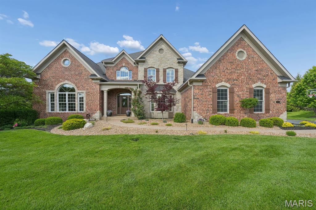 Sitting on a beautifully landscaped 1.2 acres, this stunning one and a half-story home is perfect for the discriminating buyer who understands quality construction. You’ll feel immediately at home here, as you come inside to a two-story entry foyer with an elegant, curved staircase and warm wood floors. The bright office will make you love working from home. The main level living areas are open and inviting—well-suited to spending time with friends and family. You will love to relax around the gas fireplace in the great room, and a wet bar connects to the kitchen for easy entertaining. The cozy hearth room off the kitchen is the perfect spot for coffee on a cool morning. The showstopper of a kitchen is equipped to cater to any meal from the everyday to elaborate holiday spreads and offers sleek expansive counters, a center island, a walk-in pantry, and luxury appliances including a SubZero refrigerator and a Wolf range and wall oven. Casual meals can be served in the breakfast room or enjoyed at the bar seating, while the dining room is ready for more formal occasions. A surround sound speaker system throughout the main level and upper patio lets you play DJ everyday. Outside, enjoy summer barbecues and nice weather in the fenced in backyard with lush landscaping and two patios. A mudroom area keeps things tidy as you come in from the 3-car side entry garage, and main floor laundry keeps laundry from being too much of a chore. At the end of the day, you will love retiring to the primary bedroom suite which has a luxurious full bath with a spacious walk-through shower, jetted tub, dual vanities, and a walk-in closet. Upstairs, there’s room for everyone else with three more bedrooms, all with their own private bathrooms and walk-in closets. An additional living room and a sitting area give everyone space to spread out. Downstairs, the walk-out lower level is ready for you to finish to your taste—the egress window and rough-in give you a head start!