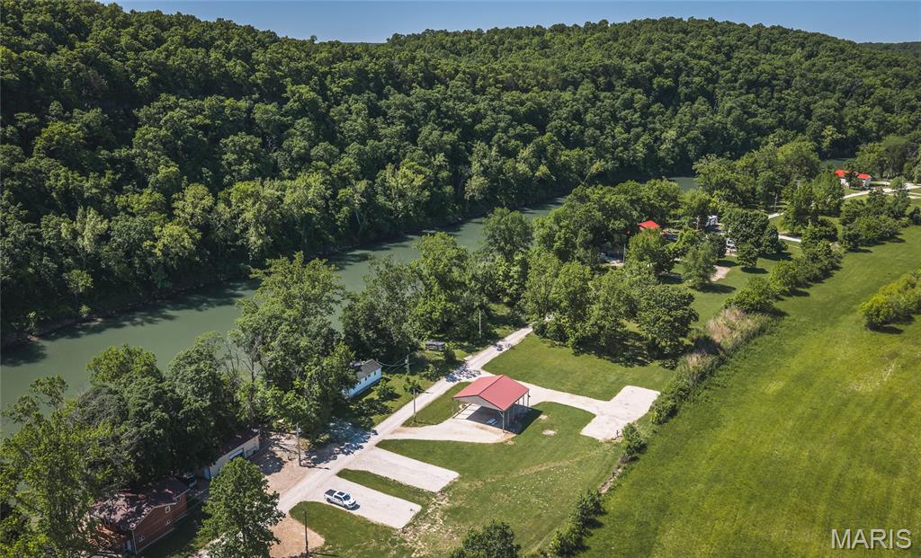 Tucked away near the beautiful Gasconade River, this unique riverfront getaway property is the perfect escape for outdoor enthusiasts, weekend campers, or anyone dreaming of their own private retreat in the Missouri countryside. Whether you’re gathering around a campfire under the stars, spending your days floating the river, or simply enjoying the peace and quiet of nature, this property offers the ideal setting to relax and recharge. At the heart of the property is an oversized gazebo already equipped with electric, creating the perfect covered space for entertaining, outdoor dining, or setting up your camper in comfort. Two additional RV spots are already in place with water, sewer, and electric hookups, making it easy to host family and friends or create the ultimate multi-camper setup for weekends on the river. Surrounded by the natural beauty and laid-back atmosphere the Gasconade River area is known for, this property offers endless possibilities—from a private recreational retreat to an income-producing camper rental opportunity. With utilities already established and the hard work done, all that’s left is to bring your camper, your fishing poles, and your sense of adventure. Properties this close to the Gasconade River with ready-to-enjoy camper amenities don’t come around often—schedule your showing today and start making river memories this season!