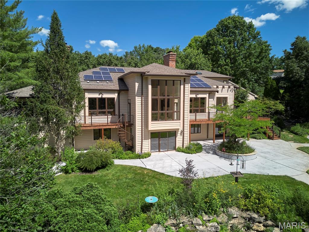 Set on 1.4 private acres within the gated Park Place enclave directly across from Queeny Park, this distinctive 5-bedroom, 5-full-bath, 2-half-bath residence offers approximately 6,350 square feet surrounded by botanical gardens, mature landscaping, a pond, a meandering stream bed with flowing water, and a PebbleTec pool with dual waterfalls. Soaring ceilings, skylights, dramatic walls of glass, and expansive living spaces create a seamless connection to the surrounding landscape. The primary suite features a sitting room with wood-burning fireplace, private deck access, dedicated study, two walk-in closets, and separate his-and-her bath areas. A second deck extends from the breakfast room into the gardens. The fully finished walk-out lower level offers guest or multi-generational living accommodations, a second kitchen, media and recreation spaces, a wine closet, workshop, walk-in cedar closet, and abundant storage. Solar panels, a three-car garage, and circular driveway add to the home's functionality and appeal. A rare opportunity to personalize a home defined by its setting, scale, and lifestyle in one of Town & Country's most desirable locations. Contact us for additional information or to schedule a private showing.