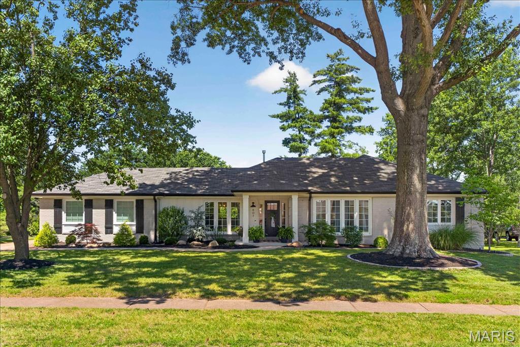 Discover this stunning ranch in desirable Claymont Estates Subdivision. This outstanding floor plan was completely gutted & reimagined in 2016 making way for a total transformation. The exterior home makes a striking first impression with an architecturally pleasing front porch, painted brick, Hardieboard siding, covered soffits, 6” black gutters with gutter guards, Board and batten shutters, thermal windows and professional landscaping & lighting: this home is a stunner in day or night! The inside is also impressive with an open floor plan, hardwood flooring, recessed lighting, neutral paint and was finished with meticulous craftsmanship. The heart of the home is the Chef’s Kitchen, equipped with; white cabinets & quiet close drawers, a sprawling quartz center island, Frigidaire professional series appliances including 5 burner gas stove/oven & second electric oven in island. A wet bar offers wine/beverage fridge & additional glass cabinetry. Entertain in the expansive family room featuring: recessed lighting, shiplap gas fireplace & French doors to the patio. 4 beds include the primary suite with walk in closet, built in second closet, rattan roman shades, en suite with his/hers sink & tile surrounded glass enclosed shower. A linen closet was added to accommodate three other beds with ceiling fans, neutral paint & loads of natural light which share the second full bath boasting tub/shower combo, dual vanity & newer hardware. The finished lower level boasts a spacious rec room, half bath (with rough in for shower), large storage closet, neutral carpet. Outside is truly an amazing oasis, the covered back aggregate patio offers electric radiant heaters, wood slatted ceiling with ceiling fan & recessed lighting. Additional paver patio hosts a firepit perfect for fall nights overlooking the common ground! Located on half an acre backing to common ground this setting is truly picturesque. Other upgrades include; solid wood doors, wrought iron hardware, nest thermostat, hard wired smoke detectors, sump pump, drain tile system, increase of attic insulation, additional parking for 4-6 cars in the concrete driveway, basketball hoop, sod/landscape to south of property, 5” baseboards in main & LL & more!!!! This one is a MUST see!