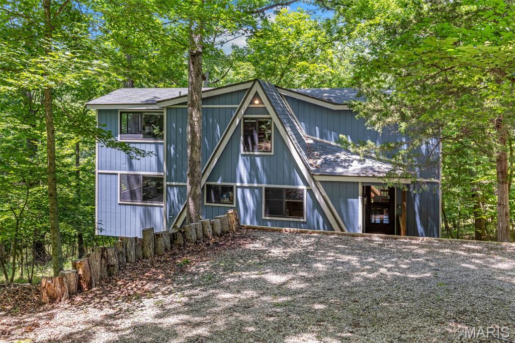 This is the waterfront chalet you’ve been waiting for at Innsbrook. Freshly painted and beautifully positioned on Lake Wynnbrook, this 3-bedroom plus loft chalet offers the lakefront setting, space, and location buyers love at Innsbrook. Set on over 2 acres with easy access and a private lakeside dock, the property is ideal for fishing, kayaking, relaxing by the water, and enjoying the natural beauty of Innsbrook. The double-level deck soars above the lake like a treehouse, creating the perfect place for morning coffee, afternoon lounging, and evenings overlooking the water. Inside, the home is filled with natural light, with a large living room featuring a wood-burning fireplace and a spacious kitchen with a separate dining area, making the chalet easy to enjoy with family and friends. The main-floor primary suite includes a full bath, with convenient main-floor laundry, two additional bedrooms on the second level with additional spaciious loft, and a second full bath. Whether used as a vacation getaway or rented when the owner chooses, this chalet offers flexibility along with classic Innsbrook charm. Located in a sought-after area of Innsbrook and connected to the sewer system, this property combines practical updates with a special lakefront setting.