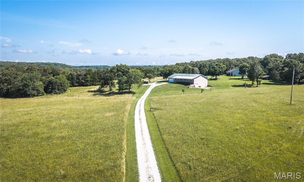 Welcome to your own slice of country paradise! Nestled on 15.32 picturesque acres of mostly open pasture, this spacious 3-bedroom, 2-bath home offers the perfect blend of comfort, functionality, and breathtaking rural views. Whether you're dreaming of a hobby farm, room for horses, or simply a peaceful place to call home, this property delivers the space and freedom you've been searching for. Inside, you'll find approximately 2,400 square feet of thoughtfully designed living space featuring an inviting open floor plan that's perfect for everyday living and entertaining. Luxury vinyl plank flooring flows throughout the main living areas, while generously sized rooms provide plenty of space for family and guests. The oversized pantry keeps the kitchen organized, and the cozy pellet stove offers an efficient way to stay warm while helping reduce heating costs. Recent updates, including a new HVAC system and a new roof installed in 2025, provide added peace of mind for years to come. The full unfinished basement offers extra garage space and endless possibilities for future expansion, storage, or a workshop. The oversized 22' x 40' attached two-car garage provides ample room for vehicles, equipment, and recreational toys. Wake up to panoramic countryside views, enjoy wide-open spaces, and experience the tranquility of rural living—all while having a beautiful home that's ready for its next chapter. Don't miss this incredible opportunity to own acreage with room to grow. Schedule your private showing today!