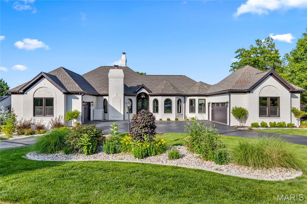 This spectacular atrium ranch exemplifies classic architecture with a fresh exterior & interior perspective. Step through the vaulted porch entrance with 8' double doors with wrought iron glass panels into the impressive foyer and private study with French doors, marble fireplace & built-in bookcase. The gracious dining room with wide bay window transitions seamlessly into the striking great room with cathedral ceiling, floor-to-ceiling stone fireplace, wet bar, skylights and a dramatic wall of windows. The designer kitchen with 42-inch white cabinetry, quartz countertops, premium stainless steel appliances & 7’ center island opens to a light-filled breakfast room & adjacent screened porch providing a relaxing retreat. The primary bedroom suite radiates warmth with a direct vent fireplace, customized walk-in closet & spa-like bath with expanded walk-in shower & freestanding jetted tub. 3 Generous-sized additional bedrooms, 2 with Jack n’ Jill bath, complete the main floor living quarters. Broad atrium staircase accesses Lower Level entertainment space with expansive recreation room with brick fireplace & 10’ wet bar, game room & wine room plus workout room with FitSauna, 5th & 6th bedrooms & full bath. French doors open to inviting outdoor living area with deck, well-equipped kitchen, pavilion with linear fireplace, resort style pool & koi pond surrounded by landscaped gardens. Enjoy a sought-after golf community lifestyle with access to clubhouse, pool, tennis courts, fitness center and a 36-hole championship golf course just a short walk or cart ride away.