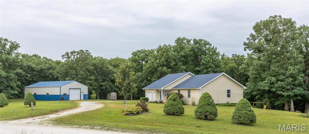 Discover the perfect combination of privacy, space, and convenience with this one-owner ranch home, built in 2007 and situated on approximately 6 wooded acres at the edge of town. Enjoy the peaceful setting while being just minutes from local amenities.

Designed for comfortable main-level living, this home offers an attached 2-car garage, main-floor laundry conveniently located off the full bathroom, and a spacious primary suite featuring a private full bath with a walk-in shower. The open and functional floor plan provides a welcoming atmosphere for everyday living and entertaining.

The full walkout basement offers endless possibilities for future expansion and is already equipped with a rough-in for an additional bathroom, allowing you to customize the space to fit your needs.

Outside, you'll appreciate the impressive 30' x 52' metal outbuilding with two overhead doors, providing exceptional space for vehicles, equipment, hobbies, or workshop use. A new roof installed on the home in 2024 adds additional peace of mind as well as a geothermal system for lower utilities.

If you've been searching for acreage, a quality-built home, and the convenience of living on the edge of town, this property is one you won't want to miss!