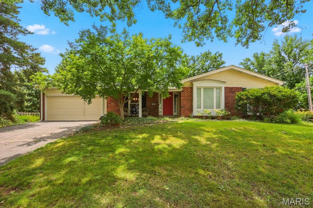 Superb!! describes this 3-bedroom, 2-bath single-family home at 12080 Spruce Haven Drive. This home offers a perfect blend of comfort and convenience. The home features 1,719 sq. ft. of living space on a generous 0.28-acre lot and is minutes away from Hwy 270 and shopping.  This home boasting a large master bedroom with updated en-suite and walkout to patio, vaulted family room with dedicated fireplace, updated vaulted kitchen with large bay window and stainless-steel appliances, newer hardwood flooring, main floor laundry, newer windows. siding, roof and oversize 2 car garage.  Additional updates: electrical panel, new security system, and patio. Hurry!!
