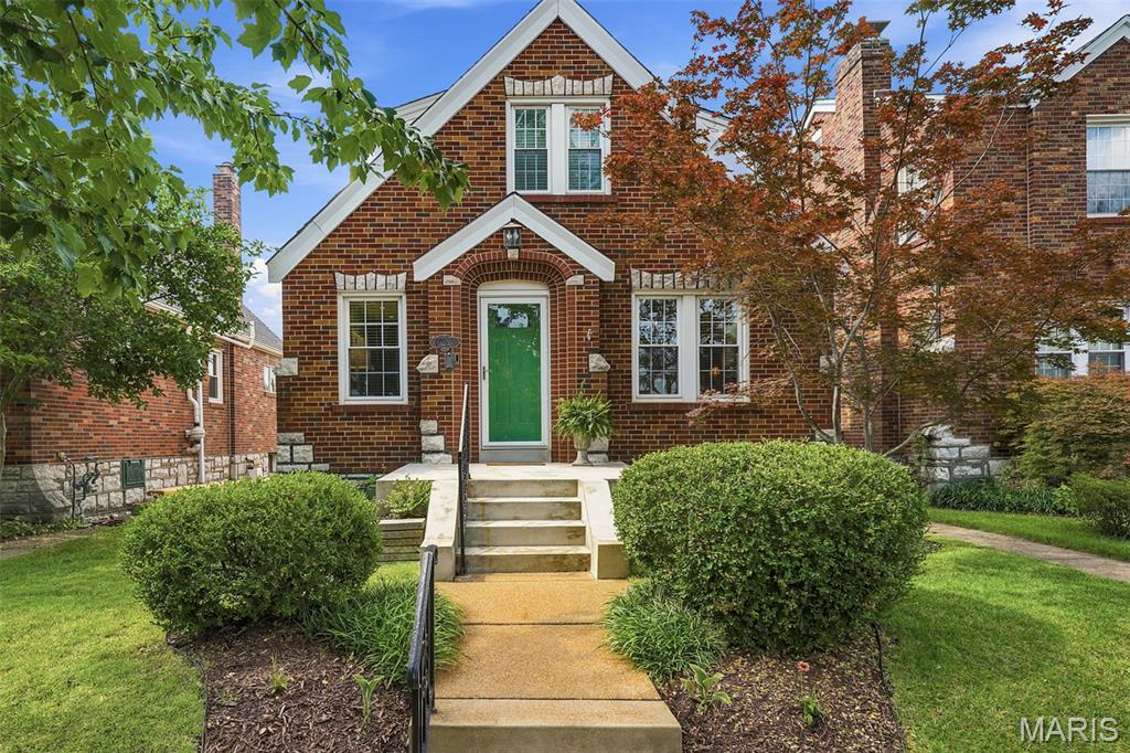 This house doesn’t just have living spaces – it has LIVING VIBES. Get ready to fall in love with this 3 bed, 2 full bath brick Gingerbread beauty in the vibrant Southwest Park neighborhood — a home that delivers charm, character and a layout that provides surprises on every level.
Hardwood floors run throughout the main and upper levels, and the sun splashed living room and dining rooms show off classic and stained glass windows that give the home its historic charm. Enjoy true main floor living with a bedroom and updated full bath. The open, updated kitchen is a total showstopper — high end GE stainless appliances, granite counters, a gas cooktop with swing out pot filler, and a versatile island that flips into a breakfast bar. The kitchen flows right into the bright dining room, making hosting effortless. Head through the mud room (complete with pantry and storage) and step into your backyard oasis — an outdoor hangout zone built for good times. Think custom covered, wood clad outdoor TV mount (TV not included), a permanent stone firepit, and a custom granite topped bar (the decerning eye will notice it is the same granite as in the indoor kitchen) that is perfect as an outdoor kitchen and grill area. It’s basically an outdoor living room, plus plenty of grass for both your 4 and 2 legged friends. Upstairs, you’ll find two more bedrooms and an updated full bath. Downstairs, the finished lower level gives you three bonus spaces: a cozy TV room, a dry bar (full size fridge included) and a flex area perfect for an office, game room, or creative studio. A fully fenced backyard and 2 car garage with alley access rounds out the perks. This is city living at its finest — you’re 5 minutes from Forest Park, the Botanical Garden, major hospitals, freeways and some of St. Louis’ most buzz worthy restaurants. And the walkability? A perfect 10.  Indoor charm + outdoor oasis + finished lower level = your new hosting headquarters.  See this home today!