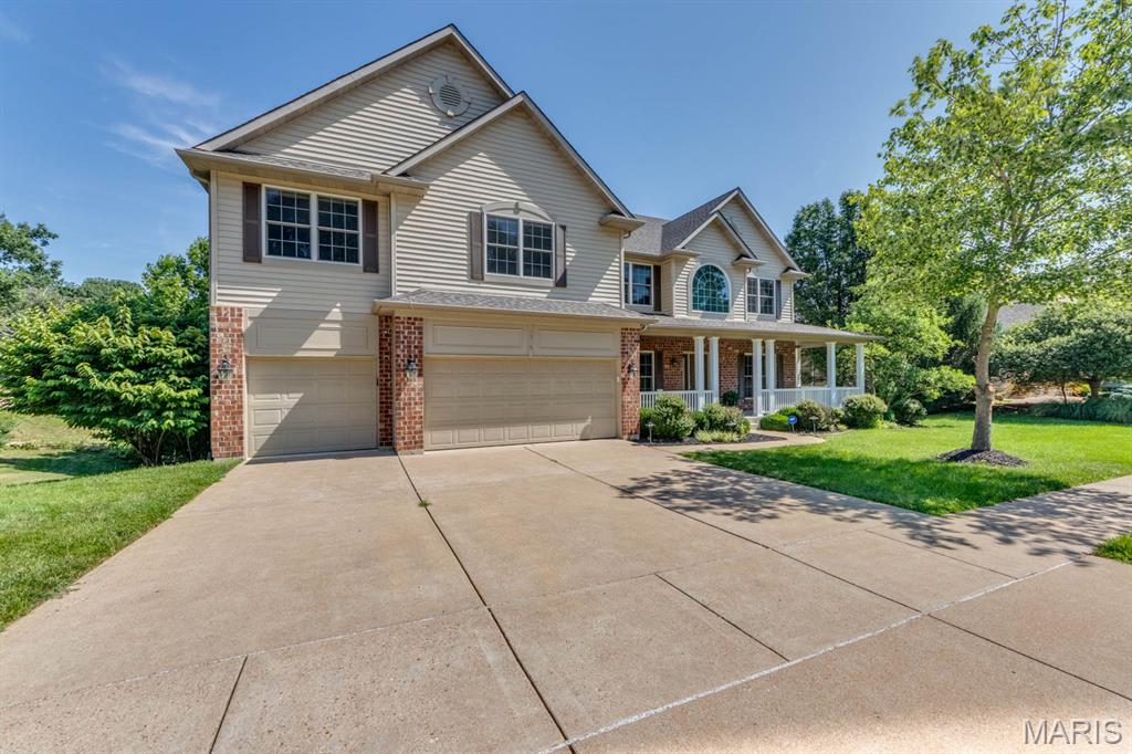 This impressive 5 bedroom, 4 1/2 bath two story is nestled on a premium lot backing to wooded common ground. Pass the charming covered front porch, the wooded entry provides open views of the formal living areas accented with wainscoting and crown molding.  The living room leads to the family room with a gas fireplace & 5 window bay, The well- appointed kitchen has 42 'cabinetry, granite counters, wood floors, island/breakfast bar, a walk-in pantry & opens to the hearth room featuring a second gas fireplace. Access the18 x10 composite deck from the breakfast room. The main floor laundry room is complete with an oversized washer/dryer & utility sink. The rear staircase leads to a huge master suite that is separated from the other bedrooms and offers a luxury bath with jet tub/shower, water closet, dual vanities. 3 bedrooms with private baths & a loft complete this floor. The lower level has an office (5th bedroom) full bath, rec room with wet bar. Updates and upgrades include new paint & carpet throughout 06/2025, newer HVAC system installed in 2022, roof 2015, zoned heating/cooling, lawn sprinklers system, 9ft ceiling on main floor and basement. This home was built by Fischer & Fritchel.