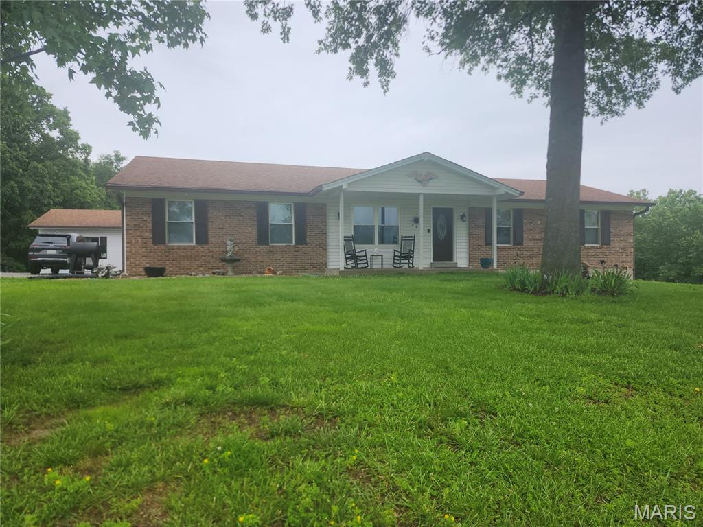 Check out this Amazing 4 bed 3 bath w/bonus room home just minutes from Hwy 61 off West Hwy U. This home has had many updates done to the home, but still leaves enough for you to but your own style on it. the home sits on a double lot which gives it a full 3 acres. Not only does the home have a full 2 car garage it also has a detached oversized 1 car garage. The lot has the best of both worlds. it has some trees behind the home to give you plenty of privacy and a lot of open space on the side and around the back as well for the kids to play. the home sits at the end of a cel de sac, so you won't get much of the subdivision traffic. 
  On the main floor the home as 3 nice size bedrooms along with a main bath and master bath.  This place as 2 living rooms! They are both fair size the 2nd living room has a beautiful stone fireplace in it for them cozy family evening. Out of the eat-in dinning area there is an amazing screened in porch that leads to a open air deck. In the full walk out basement they have the Laundry, Storage room and another bedroom with egress window. there is also a bonus room with a closet, which would work great for an office or gym area. The basement also has a full bath close to the walkout door, so when you come in from doing yard work or just playing in the yard you could get cleaned up before going into the main living area. When you leave the basement you will enter a full fenced in area with nice looking black chain link fence, which could be great for keeping the pets or kids from escaping! This home is a must see! If you are Looking for a great home on a great piece of land in a nice neighborhood, close to the Hwy. Here you go!