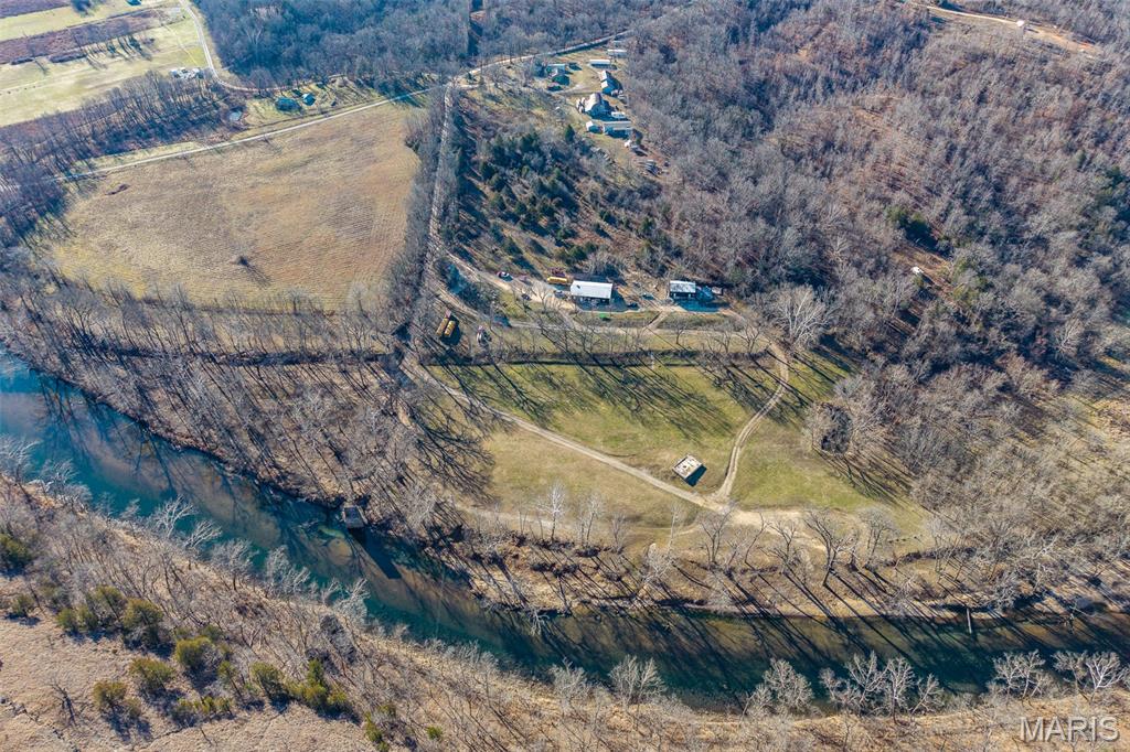 EXCEPTIONAL RIVERFRONT CAMPGROUND WITH OVER 36 ACRES-SMOKEY BOTTOM RESORT!  Extraordinary opportunity nestled on the Niangua River.  This remarkable property offers endless possibilities for entrepreneurs, outdoor enthusiasts, multi-generational families, and investors with tremendous income potential!  A stunning riverfront retreat with an established campground offering everything you need- complete with RV hookups, electric sites, primitive camping options, a his-and-hers bathhouse, storefront, office, and a river outfitter business.  The property's prime location along the water creates a serene backdrop that guests will return to season after season, and history lovers will appreciate the original Corkery home and old piers from the bridge!  The property offers 2 homes, an additional hookup for another home, multiple outbuildings, barns, and a ton of income potential!  Don't miss this rare chance to own an income-generating property while living the dream in one of the state's most beautiful settings.  The combination of established infrastructure, prime riverfront positioning, and versatile spaces makes this an investment worth exploring.  Schedule your private tour today, and envision the possibilities waiting at this one-of-a-kind riverside haven! DUPLICATE LISTING OF MLS#26005736