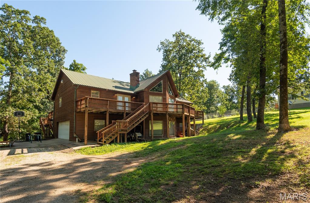 Welcome home to this beautiful, cedar-sided haven that perfectly blends rustic charm with spacious, modern living. Boasting 4 bedrooms and 3 full bathrooms, this property offers all the space your family needs to grow, entertain, and unwind.

Step inside the main living room and prepare to be wowed by the magnificent vaulted cedar wood ceilings, creating an airy yet incredibly cozy atmosphere. It features the first of two magnificent wood-burning fireplaces—perfect for curling up with a good book on chilly evenings.

Need more space? Head into the expansive, separate family room, which features its own dedicated wood-burning fireplace. Whether you picture a game room, a home theater, or the ultimate holiday gathering space, this second living area delivers endless possibilities.