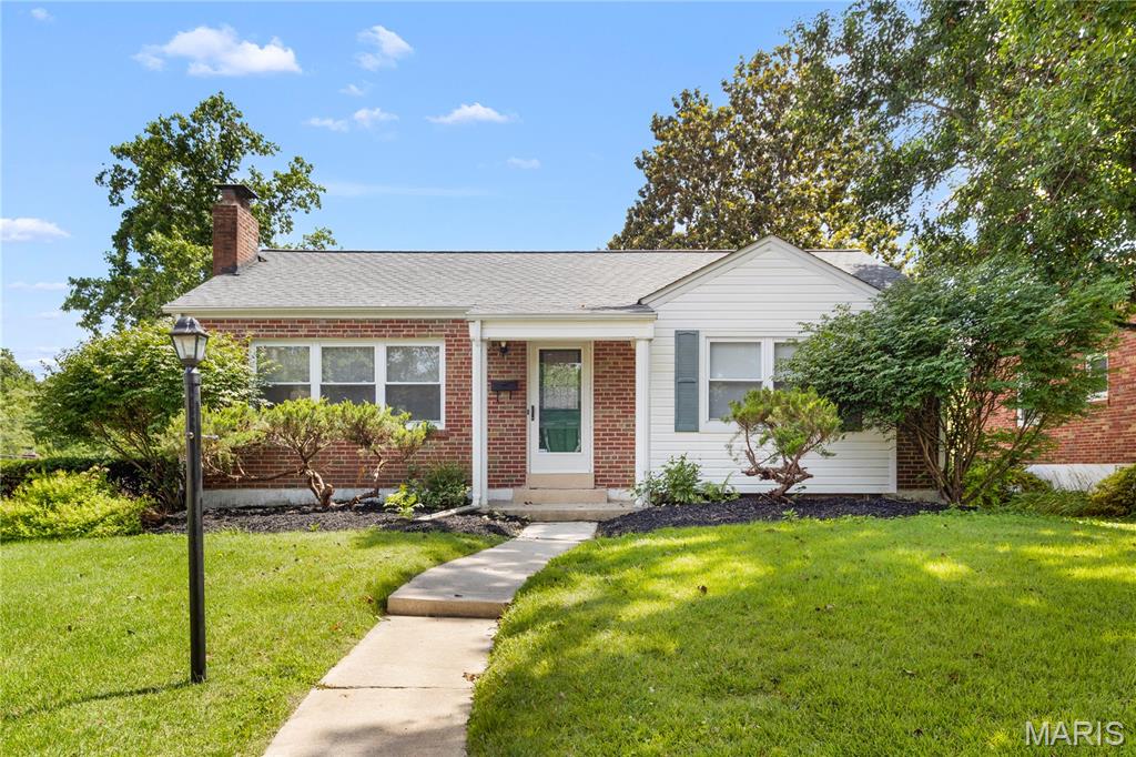 Welcome to this beautifully renovated brick bungalow in Webster! Situated on a spacious corner lot, this home has great curb appeal with lovely landscaping, large shade trees, and a side-entry garage. Inside, the bright living room features built-in bookshelves and gleaming hardwoods that continue throughout the home. Perfect for entertaining, the dining room is open to the living room and kitchen. You'll love the white shaker cabinets, quartz counters, stylish black fixtures, and stainless steel appliances. A few steps down is the charming family room with high ceilings, laminate floors, and tons of natural light. The updated bathroom has a tile-surround tub and tile floors, a new vanity, black fixtures and modern lighting. Two bedrooms complete the main level. You'll have plenty of storage in the large unfinished basement and the outdoor shed. Enjoy grilling with friends and family on the patio in the fenced backyard. There's room for off-street parking on the u-shaped drive. In a great location just moments from Webster Rec Plex, Memorial Park, and downtown Webster, plus all of the shops and restaurants along Watson Road, and quick access to I-44, this home is just what you've been dreaming of! Don't miss out!