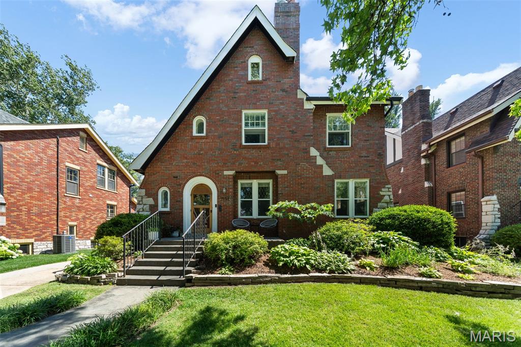 Est. 1930, this beautifully updated 5-bedroom, 2.5-bath University City home offers over 2,700 square feet of finished space in the highly walkable University Park neighborhood. Combining timeless character with thoughtful updates, this stately 2-story brick home features striking curb appeal, mature landscaping, and a welcoming front porch. Inside, you’ll find spacious, light-filled rooms with hardwood floors, arched doorways, terrazzo detailing, leaded glass windows, and a gas fireplace. The open main level includes a generous living room, formal dining room, a convenient half bathroom and an updated kitchen featuring a 2022 48" Bertazzoni 6-burner dual fuel range, a great center island, abundant cabinetry, and premium appliances—perfect for everyday living and entertaining. The second floor offers separately zoned HVAC for comfort, three generous bedrooms and two updated bathrooms, including a true primary suite with a large walk-in closet and private bath. The 3rd floor offers two additional bedrooms—or great dual home office options—and lots of additional storage/closets. The walk-out lower level adds even more living space with a fantastic bonus theater room, laundry area, and plentiful storage. Outside, enjoy multiple entertaining spaces including a patio and new 17x16 composite deck overlooking a privacy-fenced backyard. An expanded driveway and detached two-car brick garage with built in shelving, workbench and opener provide ample off-street parking and storage. Just steps from Winslow’s Table, Heman Park, Lewis Park, Jackson Park, and the Delmar Loop, 7134 Stanford offers the perfect blend of historic charm, modern updates, and a vibrant walkable lifestyle.