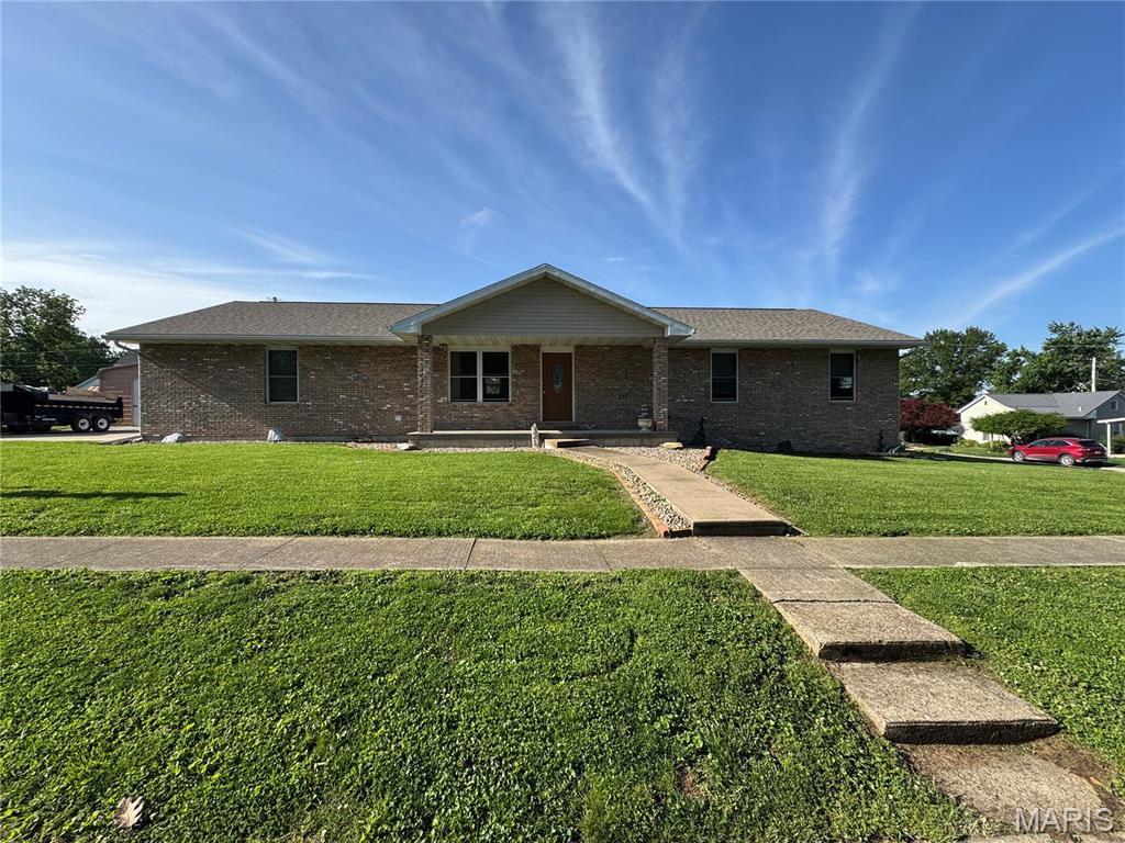 This beautiful all-brick home, built in 2010, offers the perfect combination of modern comfort, functional space, and an outstanding location. Situated on a desirable corner lot in the heart of town, this property is within walking distance to schools, shopping, dining, parks, and many everyday conveniences. With approximately 2,168 square feet of living space, the home features 5 bedrooms and 3 full bathrooms, providing plenty of room for a growing family, guests, or a home office setup. The open-concept kitchen, dining, and living room design creates a spacious and welcoming atmosphere that is perfect for entertaining or everyday living. The kitchen comes fully equipped with a refrigerator, microwave, dishwasher, and stove, all of which convey with the property. Additional quality features include a water softener, water filtration system, water manifold system, and a whole-home humidifier for added comfort and efficiency. Outside, you’ll find a large fenced-in backyard ideal for kids, pets, or gatherings, along with a back deck perfect for relaxing or grilling. The oversized 54' x 28' outbuilding provides exceptional storage, workshop space, or room for hobbies and equipment. A 2-car attached garage adds even more convenience. This home has also recently received a new roof and gutters, giving buyers added peace of mind. Properties with this much space, quality, and location do not last long. Priced to sell quickly — don’t miss your opportunity to own this move-in ready home!