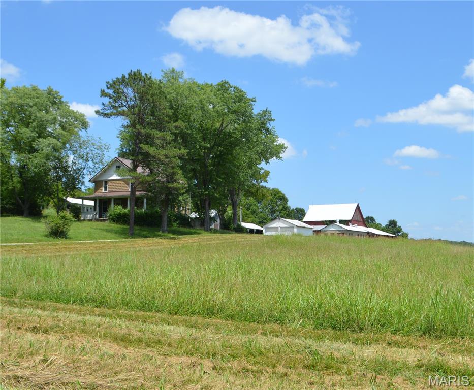 Beautiful 3-bedroom, 1-bath two-story home situated on 9.49 acres, perfect for horse or livestock enthusiasts. The property is fenced and cross-fenced and features three outbuildings, including a horse barn with stalls, a cattle barn, 2 car detach garage and a workshop/storage building. Inside, you'll find a spacious living room, kitchen, and dining room, all accented with hardwood flooring. The upstairs bedrooms are comfortably carpeted. The level acreage offers a mix of open pasture and partial woods, providing scenic views from the home and plenty of room for recreation or farming. Enjoy country living with the convenience of being just minutes from town, with easy access to highways, shopping, and schools. A great opportunity for anyone seeking a hobby farm, horse property, or peaceful rural retreat.  Professional pictures coming on 7/9/2026.