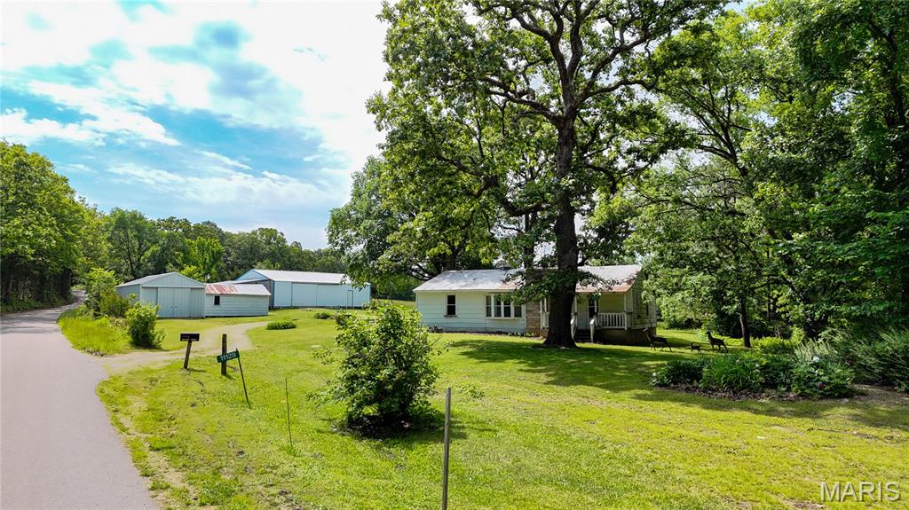 This peaceful country property offers endless potential on 3 +/- acres, the private property is approx. 5 minutes from Hwy 47 and approx. 12 minutes from Hwy 21. Situated on a quiet asphalt country road, the property features beautiful mature trees, a small field area, and scenic views of the larger acreage behind the home. Built around 1950, the home is full of character and is livable while offering the opportunity to update and make it your own. 

Perfect for a mini farm, garden, or small animals, this property includes several useful outbuildings, a large approximately 30x50 shop with lean-tos on both sides, plus an additional 18x24 garage with concrete floor, electric, and automatic garage door opener. A additional storage buildings provide even more flexibility for hobbies, livestock, or equipment.

The home, outbuildings and approximately 3 acres are being offered at this time, the buyer will have first right of refusal on the remaining 32 acres if it becomes available in the future. Whether you are looking for a fixer-upper with charm, a country retreat, or a place to create your dream homestead, this property is ready for its next owner.