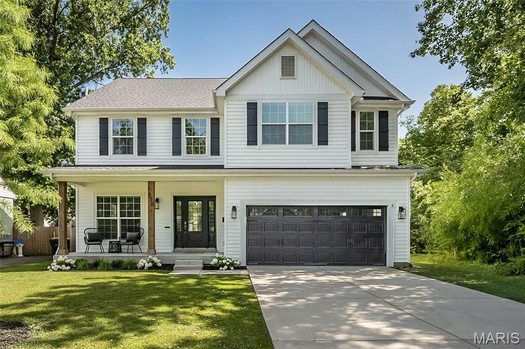Open House Friday, 7/3, 4:30 - 7:00 PM. Beautifully furnished and only four years old, this impressive 5-bedroom, 4.5-bath home offers the comfort and convenience of newer construction in highly desirable Kirkwood, just minutes from schools, dining, shopping, and everything the community has to offer. The inviting front elevation features black accents and cedar posts that lead into a striking two-story entry and an open floor plan with hickory engineered hardwood throughout the main level, continuing up the extra-wide staircase, through the second-floor hall, and into the primary bedroom. The well-appointed kitchen includes ceiling-height custom cabinetry with gold hardware, quartz countertops, a subway tile backsplash, stainless steel appliances including a double oven, and a refrigerator that remains with the home. A large waterfall-style center island provides seating for four, a drawer-style microwave, and cabinetry on both sides, while the nearby butler’s pantry—ideal for a coffee center or extra pantry space—features a custom pass-through to the spacious dining room with beautiful wainscoting. The breakfast area and great room add to the open feel of the home with a custom fireplace surround, white birch gas logs, black accents, a flat-screen TV, built-ins for storage, and crown molding. The garage foyer offers custom cabinetry for a convenient drop zone, and the oversized two-car garage includes extra space for a workshop or storage, a Tesla charging outlet, and Beam central vacuum components. Upstairs, the primary bedroom en-suite features a coffered ceiling, heated tile bathroom floor, customized shelving, a wall safe, and a pocket office in the walk-in closet. Bedroom two includes its own en-suite bath, while bedrooms three and four offer walk-in closets. The second-floor laundry room adds everyday convenience with cabinetry and drying racks. The finished lower level provides a large family room with custom storage, a full bath, and a spacious fifth bedroom, while the utility room houses dual HVAC and a radon mitigation system. Exterior highlights include a generous .278-acre lot, an uncommon find for newer construction in Kirkwood, along with a full privacy fence, large backyard patio, Govee lighting package, full irrigation system, and leaf guard gutters. Thoughtfully designed, beautifully maintained, and move-in ready, this Kirkwood home offers an outstanding blend of style, comfort, and function.