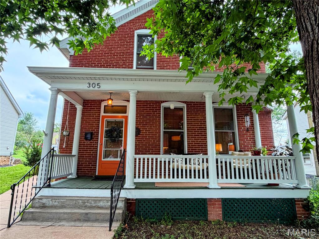 Step into timeless charm with this beautifully maintained 1915 brick home, where historic character meets modern convenience. Rich in original details, this home showcases hardwood floors, a stunning restored staircase, intricate millwork, solid wood doors, vintage hardware, soaring ceilings, and spacious rooms that highlight the craftsmanship of a bygone era.

The updated kitchen offers generous prep space, abundant cabinetry, and everyday functionality, while the inviting addition off the dining room creates extra living space accented by a striking exposed brick wall that enhances the home's warmth and character.

Relax on the covered front porch beneath mature shade trees or entertain with ease on the expansive concrete patio, perfect for outdoor gatherings. A detached shed provides excellent storage or workshop space, and two off street parking spaces are conveniently accessible from the alley.

Ideally situated within walking distance of vibrant downtown Washington, you'll enjoy easy access to boutique shopping, local restaurants, parks, the library, riverfront, walking trail, and year round community events. This is a rare opportunity to own a home that perfectly blends historic elegance, thoughtful updates, and an unbeatable location.