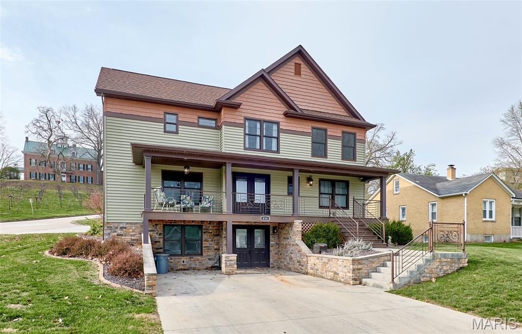 Here is luxury living right in the heart of Hermann. This completely renovated home offers nearly 3,000 sq ft of finished living space and truly feels more like new construction than a remodel. With 4 bedrooms and 4.5 bathrooms, every detail has been thoughtfully designed for comfort, function, and style.

Situated on a corner lot at the base of Stone Hill Winery, the curb appeal immediately stands out. Step onto the front porch and enter through double doors into a wide-open main floor filled with natural light. The kitchen is the centerpiece, featuring soapstone countertops, a massive island, and tons of custom cabinetry throughout. No expense was spared with Café Appliances, including a double wall oven, gas cooktop, Bosch dishwasher, and French door refrigerator, plus a wine fridge ready for entertaining.

The main floor flows seamlessly from the kitchen to the dining area to the living space, all open and connected. Just off the living area, step outside to a stamped concrete patio with professional landscaping designed for privacy. Or unwind year-round in the four-season sunroom, complete with a hot tub and an endless heated pool, perfect for relaxing or getting in a swim workout like you're in open water.

The main-floor primary suite is positioned for convenience and comfort, with direct access to the sunroom. The ensuite bathroom features a double vanity, a walk-in closet, a huge walk-in shower, and a clean, modern finish.

Upstairs, you’ll find three additional large bedrooms, each one a full suite with its own private bathroom and walk-in closet. Its high-end, highly functional layout is ideal for families or guests. A second-floor laundry room adds everyday convenience.

The walk-out basement is partially finished, with full-size windows and doors and a roughed-in bathroom. Use it for storage or easily finish it into an additional living or recreation space. Direct access to the driveway makes it practical and flexible.

This property was designed with low maintenance in mind, including minimal steps for entry from the patio side. Whether you're looking for a full-time residence, weekend escape, or a place to settle into long-term, this checks the boxes.

Homes like this, modern, fully updated, in-town Hermann with this level of finish, are hard to find. It offers the feel of new construction with all the work already done. Just show up and enjoy.