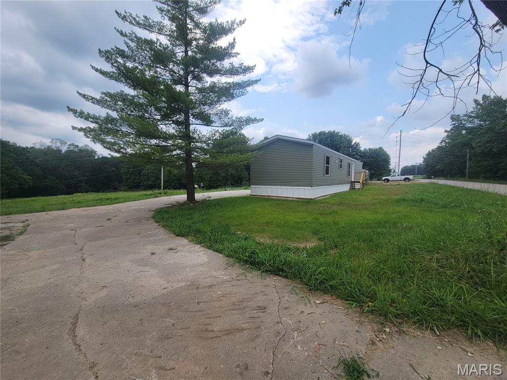 Affordable country living in Lincoln County, Mo! NO subdivision No HOA! Located near Moscow Mills, this brand new 2026 3 bed 2 full bath home is ready for you to make it your own. Galley style kitchen has an abundance of cabinets and counter space and comes ready to go with a refrigerator, microwave and stove. Master bedroom is big enough to easily fit a king sized bed and has a large closet and attached private bathroom. Home is affixed to the property and comes on a 1+/- acre lot on public water and septic system. Property lays great with enough room in the back to build a shed or shop and has a large parking area . All of this located just a few miles off of highway 61 and not far from Wentzville. Agent Owned.