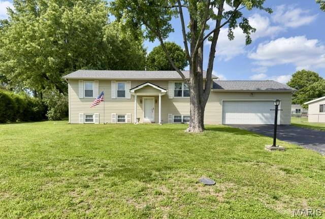 Back on the market. Located in the established Skyview subdivision, this split-foyer home offers 3 bedrooms, 1.5 baths, and 1,290 total square feet on a generous .41-acre interior lot. Step into the main level where a bright living room flows into the dining area, both with carpeting — and original hardwood flooring preserved underneath. The kitchen features a gas oven/range, and down the hall are three bedrooms with wood flooring, along with a full bathroom and a private half bath in the primary bedroom. The lower level includes a large laundry room, a concrete-floor storage area, and an additional carpeted room with an egress window that can serve as a sleeping area. Recent updates include a new roof and gutters in 2025, and the property offers an oversized two-car garage plus a detached utility shed ideal for lawn equipment or sports gear. Additional features include an 8+ ft pour, vinyl siding, central air, and forced air heat. Sitting in the Francis Howell School District and currently vacant, this home is ready for its next chapter. Home to be sold AS-IS — seller will make no repairs or provide occupancy.