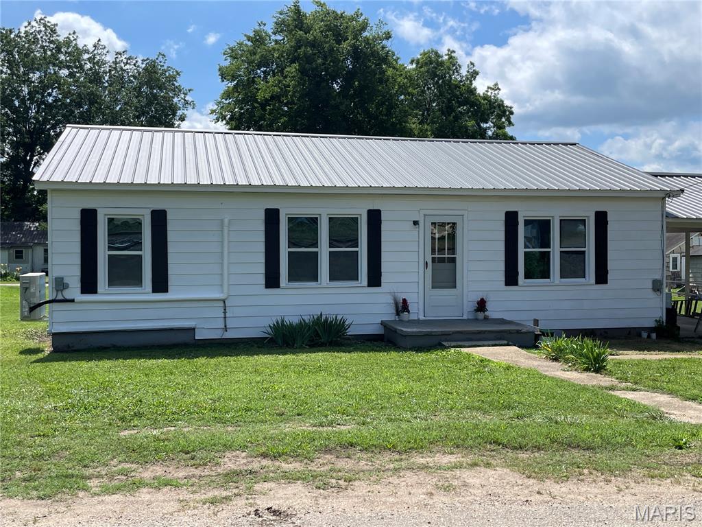 Cute, cute, cute! These are the words to describe this newly remodeled and updated house. New flooring, fixtures, paint, plumbing, heat and air, roof and shutters. Cozy, roomy living room with new fan and tin ceiling, kitchen with small bar, rustic cabinets, new countertops and appliances, all adjoining a separate dining room. Charming barn doors offer privacy and save space. Bath has a walk-in shower, custom sink and rustic wood and tin accents, with plenty of storage. There are two bedrooms and a third, smaller bedroom or office area. Attached carport, front porch and covered back porch. Level yard for entertaining or just relaxing after work.