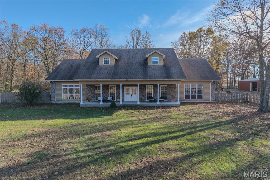 This stunning 4-bedroom, 3.5-bath home offers over 4,600 sqft of living space on 20 acres of land, providing privacy & tranquility just off State Hwy WW in Lebanon, MO.  The property features a gated entry, fenced acreage, cross fencing, & a pond—ideal for livestock. The spacious two-story home boasts an open layout, high ceilings, hardwood floors, and an abundance of natural light. The main level includes 2 large bedrooms, a master suite with dual vanities, a soaking tub, walk-in shower, and his-and-her closets. A convenient laundry chute in the home adds extra practicality. Upstairs, two oversized bedrooms share a full bath. Outside, you'll find a in ground storage shelter, 30x56 barn with electric, water & stove, a 24x40 shop with water and electric, & a 36x24 yellow shop building with electric & water, concrete floors, electric garage door, & cabinet storage. Additional 10x12 outbuildings provide even more space for storage. Privacy, acreage & a nice home this place has it all!