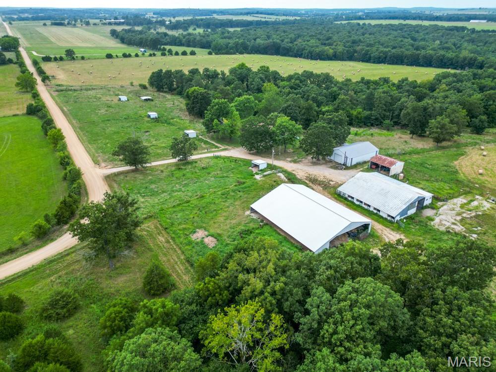 Beautiful farm perfect for cattle and horses, and your wildlife enjoyment!  169 ACRES with a mix of open and wooded land, a spring-fed creek for a year-round water source, fenced and cross-fenced, DREAM SHOP 40 X 60 w/concrete floor and electric- two 16' overhead doors for equipment access. A BARN with 5 horse stalls, tackle room and arena ,Chicken Coop, POLE BARN 60 X 100 with metal trust and lean-to for more machinery storage, 5 loafing sheds and 3 frost-free waters. Then enjoy the comfort of this UPDATED HOME with over 3,400 Sq. Ft. of living space. Gorgeous granite counter tops, & plenty of cabinetry, breakfast bar and stainless-steel appliances, dining area, (2) wood-burning fireplaces, large living room, master bedroom with updated walk-in shower in bathroom, quality laminated-wood look throughout the main level. Then, relax in the SUN-ROOM with plenty of windows to enjoy your farm view. The basement has a HUGE family room, 2 rooms that could make an office/ gym, John Deere room. Conveniently located only a few miles from Lebanon, MO. Bring your horses!