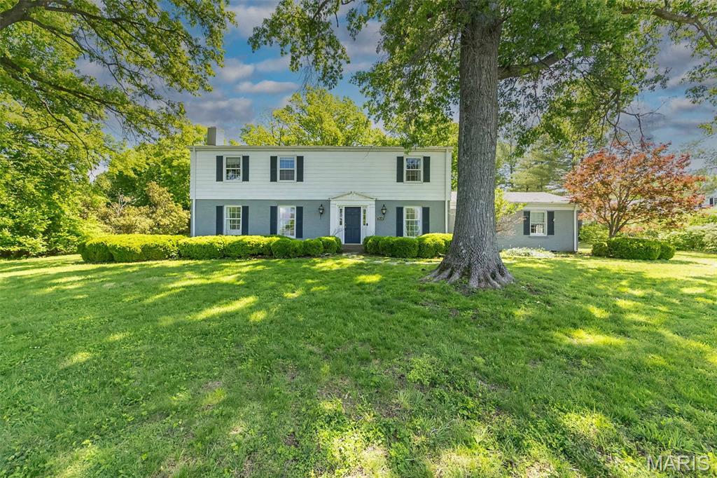 Classic New England Colonial in premier Frontenac location. This Higgenbotham-built 2 Sty features extensive millwork, custom built-ins & oak hardwoods that extend throughout the main floor. Gracious foyer leads to formal living room with marble fireplace, well-appointed dining room and family room with floor-to-ceiling brick fireplace, built-in bookcases, wet bar & half glass door that opens to brick terrace. Chef’s kitchen with granite countertops, glazed cabinetry & ample counter space adjoins light-filled breakfast room. Hardwood floors continue to the 2nd level with spacious primary bedroom suite with 2 closets, luxury bath & sitting room plus 3 additional bedrooms & hall full bath. Lower Level entertainment space includes recreation room & game room. Situated on a .98-acre lot with terrace, inground pool & oversized 2-car garage. Award-winning Ladue School district.