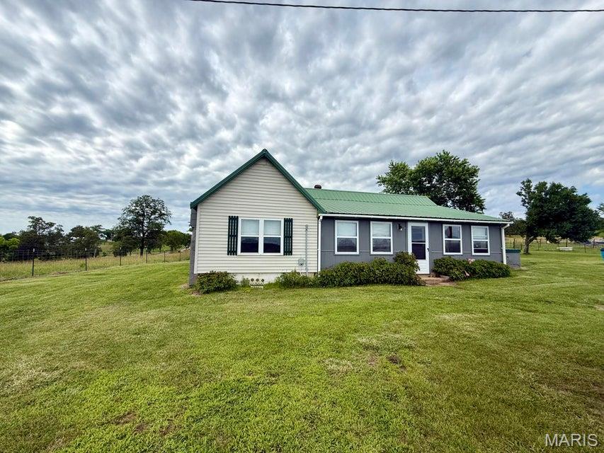Escape to the peace and quiet of the Missouri Ozarks with this charming 2-bedroom, 1-bath home situated on 0.66 acres in Elk Creek, Missouri. Nestled in a beautiful country setting, this property offers the perfect blend of comfort, efficiency, and rural living. Recent updates include two new mini-split systems, a new propane water heater, and a new refrigerator, providing modern convenience and energy efficiency. Stay comfortable year-round with the added warmth of two vent less propane wall heaters and enjoy improved airflow throughout the home with the attic fan. The spacious lot offers plenty of room for gardening, outdoor activities, or simply relaxing and taking in the peaceful surroundings. Whether you're looking for a full-time residence, weekend getaway, or investment property, this affordable country home is ready for its next owner. Enjoy the serenity of rural living while remaining within easy driving distance of Houston, Cabool, and the recreational opportunities of the Missouri Ozarks.