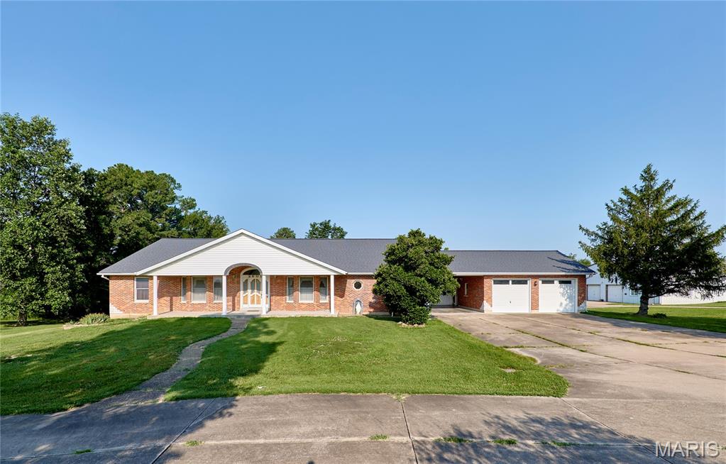 ENDLESS POSSIBILITIES AWAIT-ZONED C3!!! Exceptional all-brick ranch situated on 4.46 acres, offers the perfect blend of comfortable living and outstanding business or investment potential. Conveniently located just 1.5 miles from I-70 with blacktop frontage, this unique property features a spacious 2,551 sq. ft. home, an impressive commercial-grade outbuilding, and ample outdoor space. The home offers 3 generously sized bedrooms and 4.5 bathrooms, with each bedroom featuring its own private bath for ultimate comfort and privacy. Inside, you'll find a wide entry foyer, spacious living areas, beautiful wood-paneled doors, a wood-burning fireplace in the living room, and a main-floor laundry room that has plenty of storage for pantry items. The eat-in kitchen/dining combination includes a brand-new dishwasher and bay window, while the full partially finished walk-out basement provides abundant storage or future finishing opportunities. The home also features a wood stove for heating in the winter to keep electric costs down and central vac. Enjoy peaceful views from the 12' x 39' deck overlooking the level to gently rolling backyard or relax under the 14' x 27' covered patio that conveniently connects the home to the oversized two-car garage. The concrete driveway with circle drive offers easy access and plenty of parking. A standout feature is the massive 60' x 64' outbuilding with concrete floors, electric, office space, and two bathrooms—ideal for a variety of commercial, hobby, or storage uses. An additional storage shed with lean-to provides even more versatility. Whether you're looking for a home with room to grow, a live/work opportunity, or a property with commercial potential in a prime location, this one-of-a-kind offering checks all the boxes.