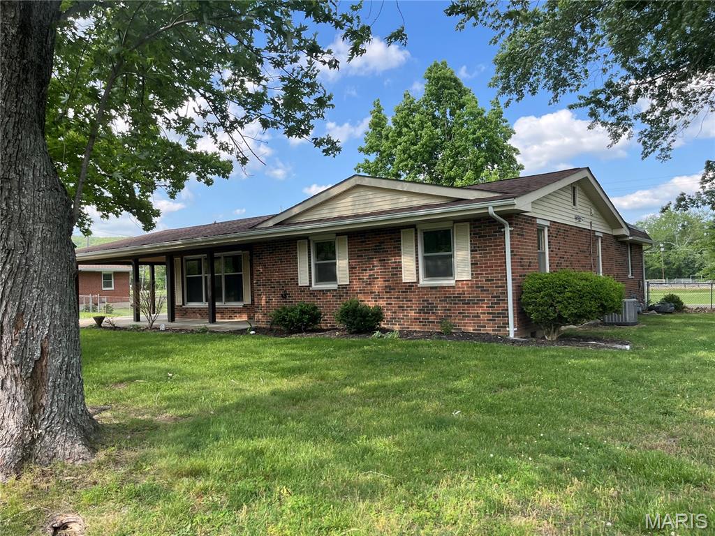 Attractive ranch-style home in a very desirable neighborhood.  This roomy home features 4 bedrooms, 2 baths, living room and family room with fireplace and bay window, kitchen with appliances and dining area in kitchen, also a large carport and a detached garage .  Home is neat and tidy and move-in-ready!
