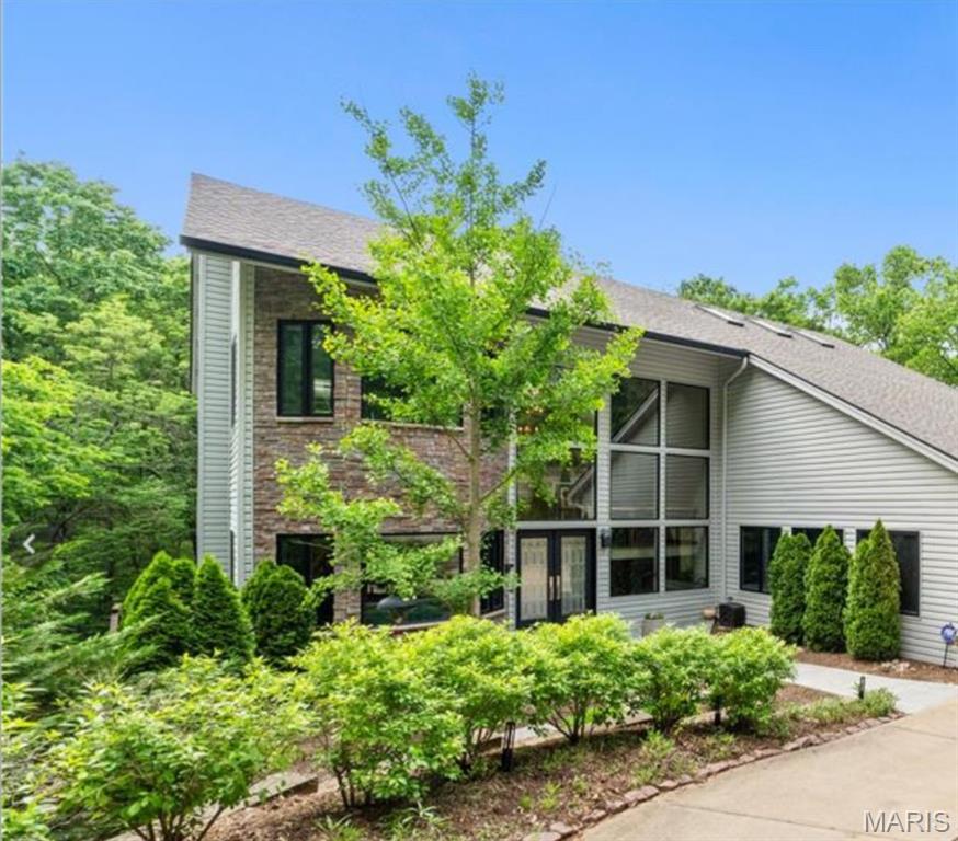 Searching for a home where you wake up feeling like you’re on vacation? Welcome to your private oasis in Kirkwood, tucked away surrounded by trees and the soothing sounds of Sugar Creek. The dramatic 2 story Great Room with Stone Fireplace gives you views of the beautiful woods on the backside of your home. The 3 car garage is a rare feature in the Kirkwood market. The kitchen perfect for quiet nights at home or for gatherings around the statement island, was completed by Mosby in 2020, with Miele, Dacor & Viking appliances.  A study with 1/2 bath, en suite bedroom & main floor laundry complete the first floor. Imagine taking a refreshing steam shower and enjoying coffee with the tranquility of the private Primary Suite’s deck or fireplace. The large Primary includes his and hers walk-in closets. A tucked away landing space and an en suite bathroom round out the upper level. The incredible lower level with full bar, a 3rd fireplace, 2 bedrooms, one en suite, another full bath, this is where you will make memories of incredible gatherings. This level walks out to the screened in porch with outdoor kitchen, updated in 2020 by Mosby with a gas grill, oven, pizza oven and sink bar. With the soundtrack of the soothing sounds of the creek and watching the changing of the leaves as fall approaches, you will make memories in your home that will last a lifetime.