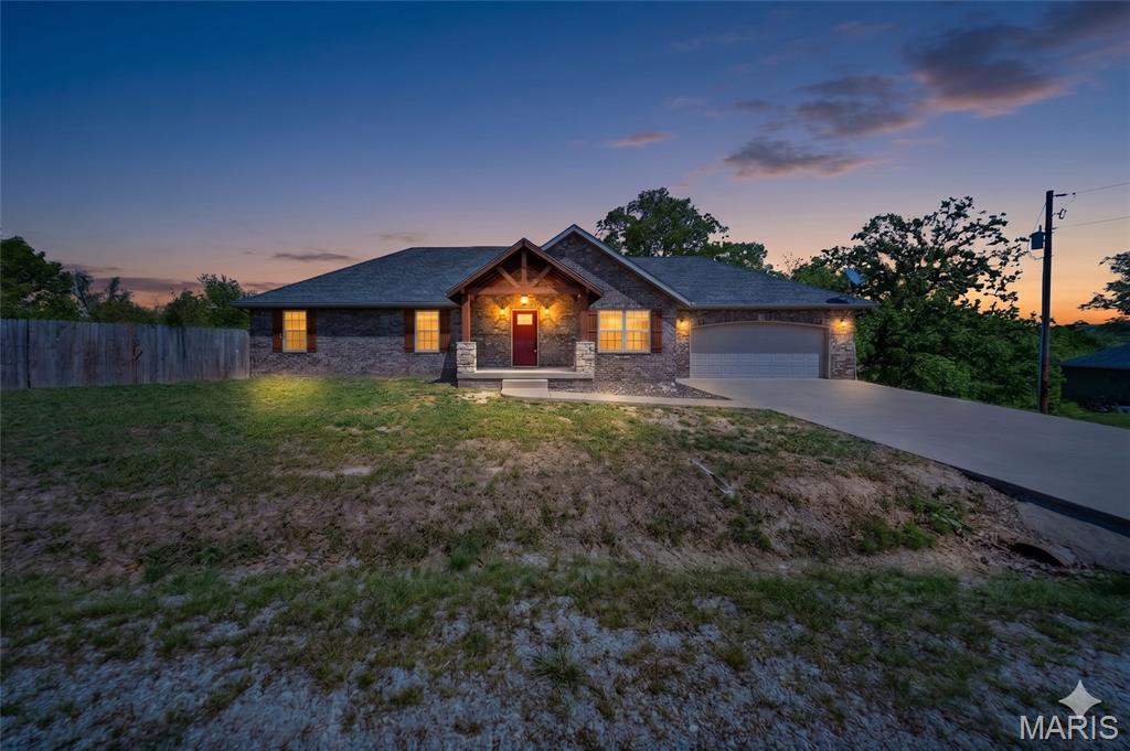 Welcome to this stunning 4 bedroom, 3 bathroom home in St. Robert, ideally located just minutes from Fort Leonard Wood and all the conveniences of town. From the moment you arrive, the inviting timber frame front porch sets the tone for the warmth and character found throughout the home. Step inside to an impressive living room featuring elegant tray ceilings, creating a spacious yet cozy atmosphere. The kitchen is designed for both function and style, offering brand new stainless steel appliances, breakfast bar seating - barstools included, and easy access to the dining area, which showcases its own tray ceiling and a beautiful chandelier. A conveniently located laundry area sits just off the kitchen. The primary suite is a true retreat, complete with tray ceilings, a generous walk-in closet, and a private ensuite bathroom featuring a double vanity and walk-in shower. Specialty ceiling fans—including a smart fan operated by the iLink app—add modern comfort and efficiency throughout the home. The fully finished walk-out basement expands your living space with a second family room, an additional bedroom, and full bathroom, plus a dedicated workout room (gym equipment included) and extra storage. This home also offers the potential for a 5th bedroom. Enjoy peace of mind with a commercial-grade HVAC system, a built-in Vivint home security system, and two 50-gallon water heaters. Outside, the fenced backyard and covered deck provide the perfect setting for relaxing or entertaining. Garden enthusiasts will love the large, established garden area featuring strawberries, blackberries, blueberries, tomatoes, potatoes, cucumbers, raspberries, peppers, garlic, lettuce, onions, broccoli, and even fruit and nut trees, including apple, peach, almond, and walnut. The adorable poultry coop & resident chickens are negotiable! With thoughtful upgrades, generous living space, and a prime location, this home truly has it all—schedule your private showing today!