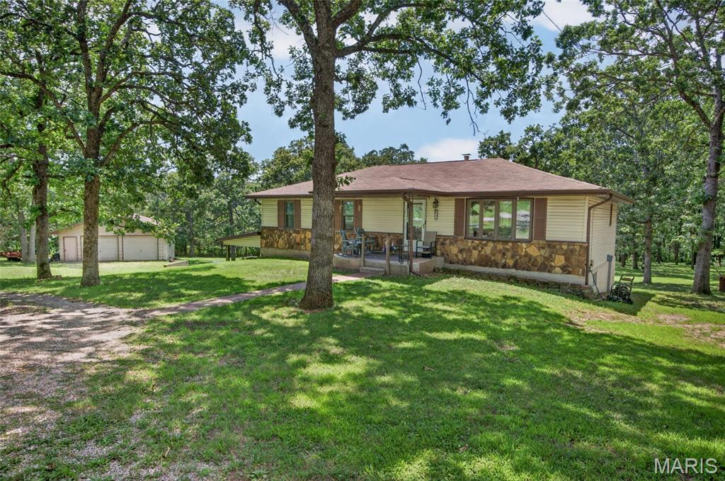 This is the one you've been waiting for. Offering the perfect balance of country space and town convenience, this affordable 4 bedroom, 2 bathroom home sits on two park like acres just five minutes outside of town. It has a two car detached garage/shop to check that box off of your "must have" list. Inside you'll find an extremely functional layout. It features a decent sized living room and a large kitchen just waiting for you to try all of those Pinterest recipes you've saved. In the basement you'll find the fourth bedroom, which could easily become an office or home gym. This is a house where you'll instantly be able to picture your future- from celebrating the holidays here, hosting back yard cookouts, and everything in between. This is one you'll want to see. Schedule your private showing today!