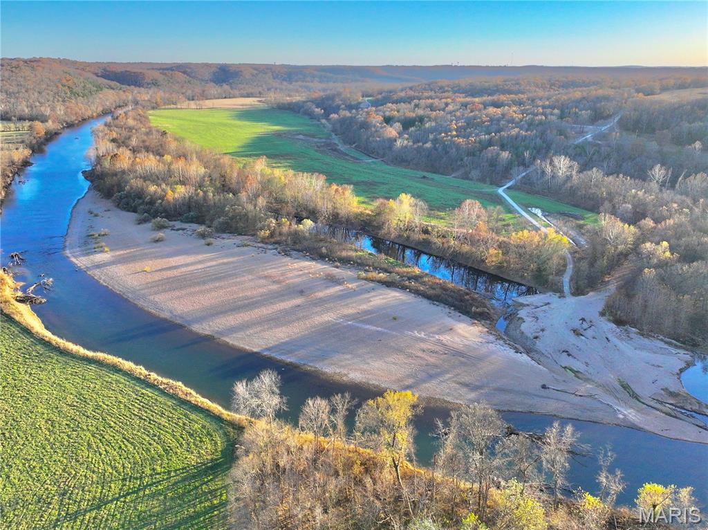 36.48M/L acres along a private stretch of the Gasconade River, offering over 1,600 ft of direct river frontage onto a massive, inviting gravel bar. This exceptional property blends fertile river bottom, beautiful timber, and open ground, providing a perfect balance for recreation, hunting, or building your dream getaway. A prime build site sits high and dry outside the floodplain with power and fiber internet on site, overlooking the scenic river bottom below.
The tract includes 10+ acres of rich, productive bottom ground—ideal for food plots, gardens, or small-scale crops. Loaded with wildlife, this area is known for big-bodied deer, strong genetics, abundant turkeys, and plenty of arrowhead hunting opportunities.
Set at the end of a dead-end county road, the property features an electric gate offering privacy, security, and ease of access, opening to 2+ miles of private gravel roads perfect for walking, biking, or ATV riding. Multiple potential build locations allow you to tailor your layout to your vision—river views, wooded seclusion, or elevated vistas.
With adjoining acreage available upon request, this is a rare chance to own premium Gasconade River ground in a secluded setting with public access points miles away. A true outdoor paradise ready for your next chapter.